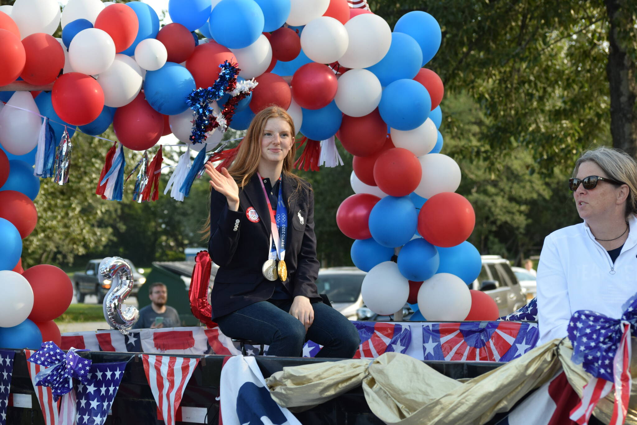 Olympic gold medalist Lydia Jacoby waves to the crowd in Seward during her celebratory parade on Thursday, August 5, 2021. (Camille Botello / Peninsula Clarion)