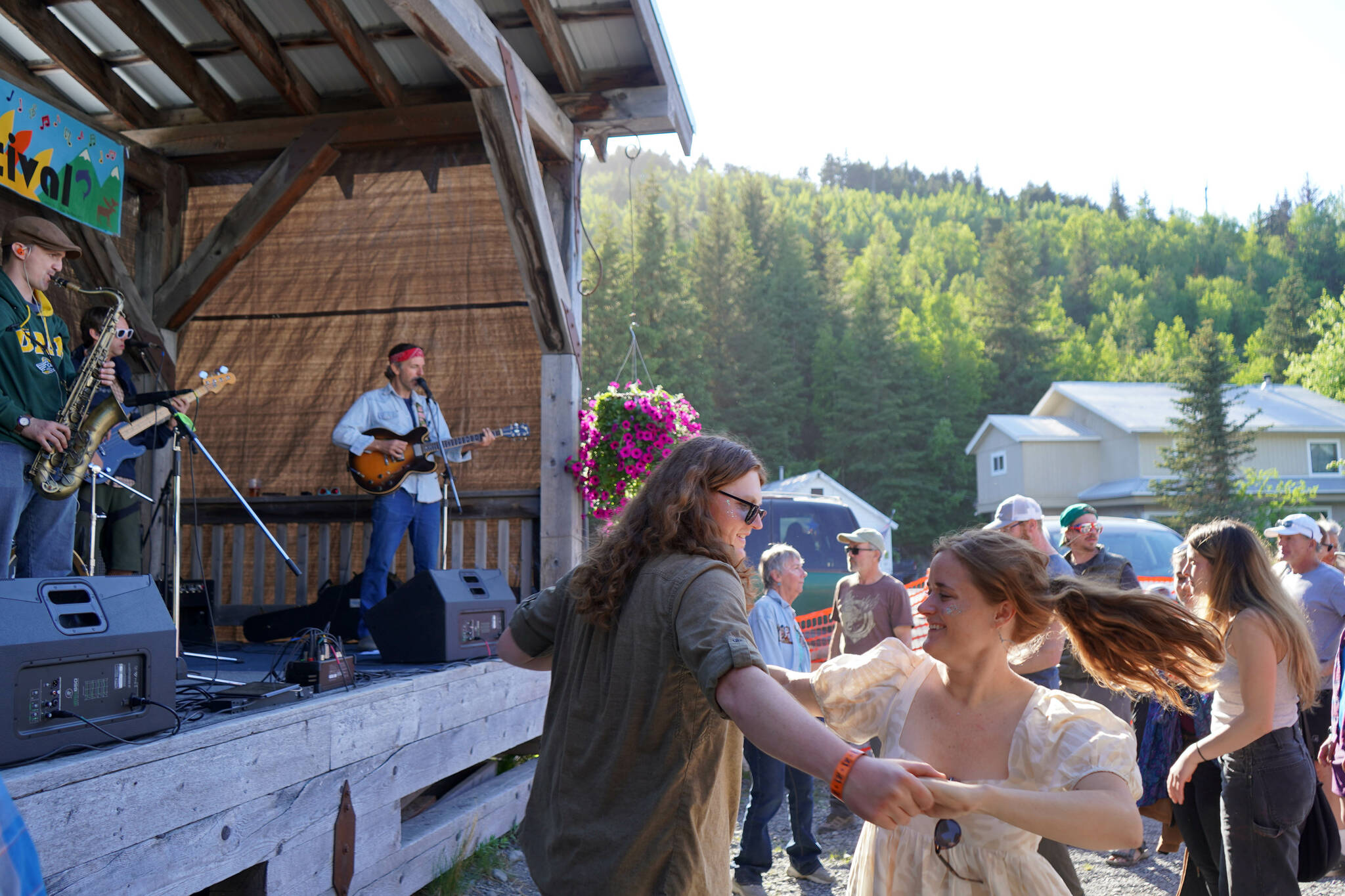 Dillon Diering and Sarah Overholt dance while the Tyson James Band performs during the 45th Annual Moose Pass Summer Solstice Festival in Moose Pass, Alaska, on Saturday, June 15, 2024. (Jake Dye/Peninsula Clarion)