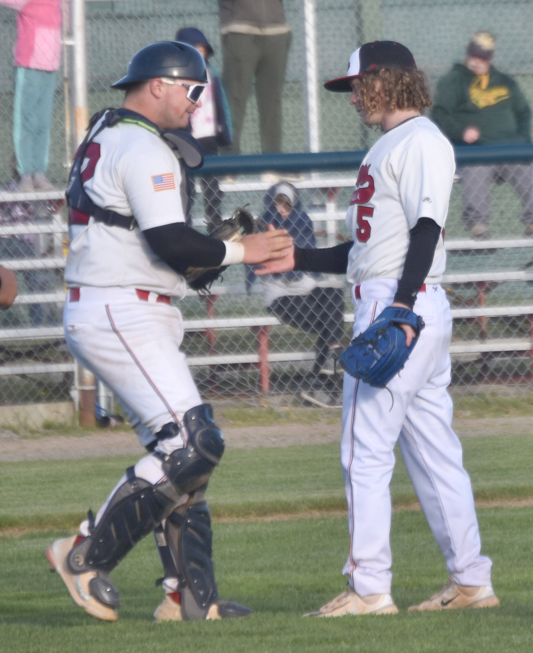 Peninsula Oilers catcher Brock Wirthgen congratulates pitcher Mose Hayes after a victory over the Mat-Su Miners on Tuesday, June 18, 2024, at Coral Seymour Memorial Park in Kenai, Alaska. (Photo by Jeff Helminiak/Peninsula Clarion)