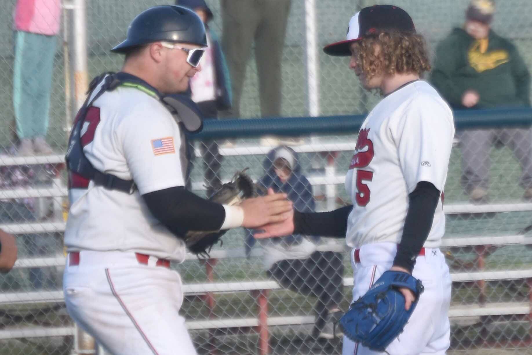 Peninsula Oilers catcher Brock Wirthgen congratulates pitcher Mose Hayes after a victory over the Mat-Su Miners on Tuesday, June 18, 2024, at Coral Seymour Memorial Park in Kenai, Alaska. (Photo by Jeff Helminiak/Peninsula Clarion)
