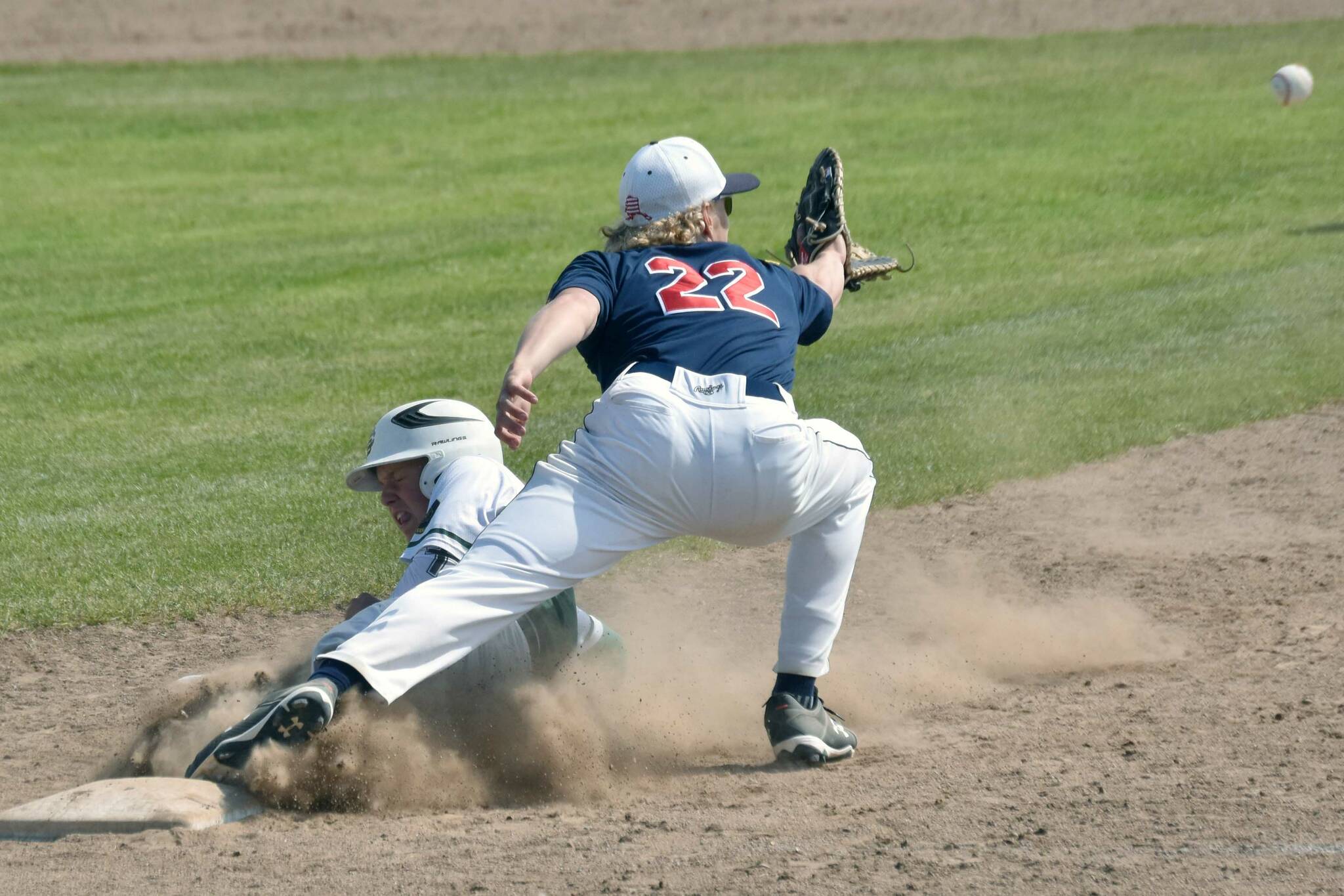 Service's Landon Martindale gets back to first base safely in front of Post 20 Twins first baseman Matthew Schilling on Sunday, June 23, 2024, at Coral Seymour Memorial Park in Kenai, Alaska. (Photo by Jeff Helminiak/Peninsula Clarion)