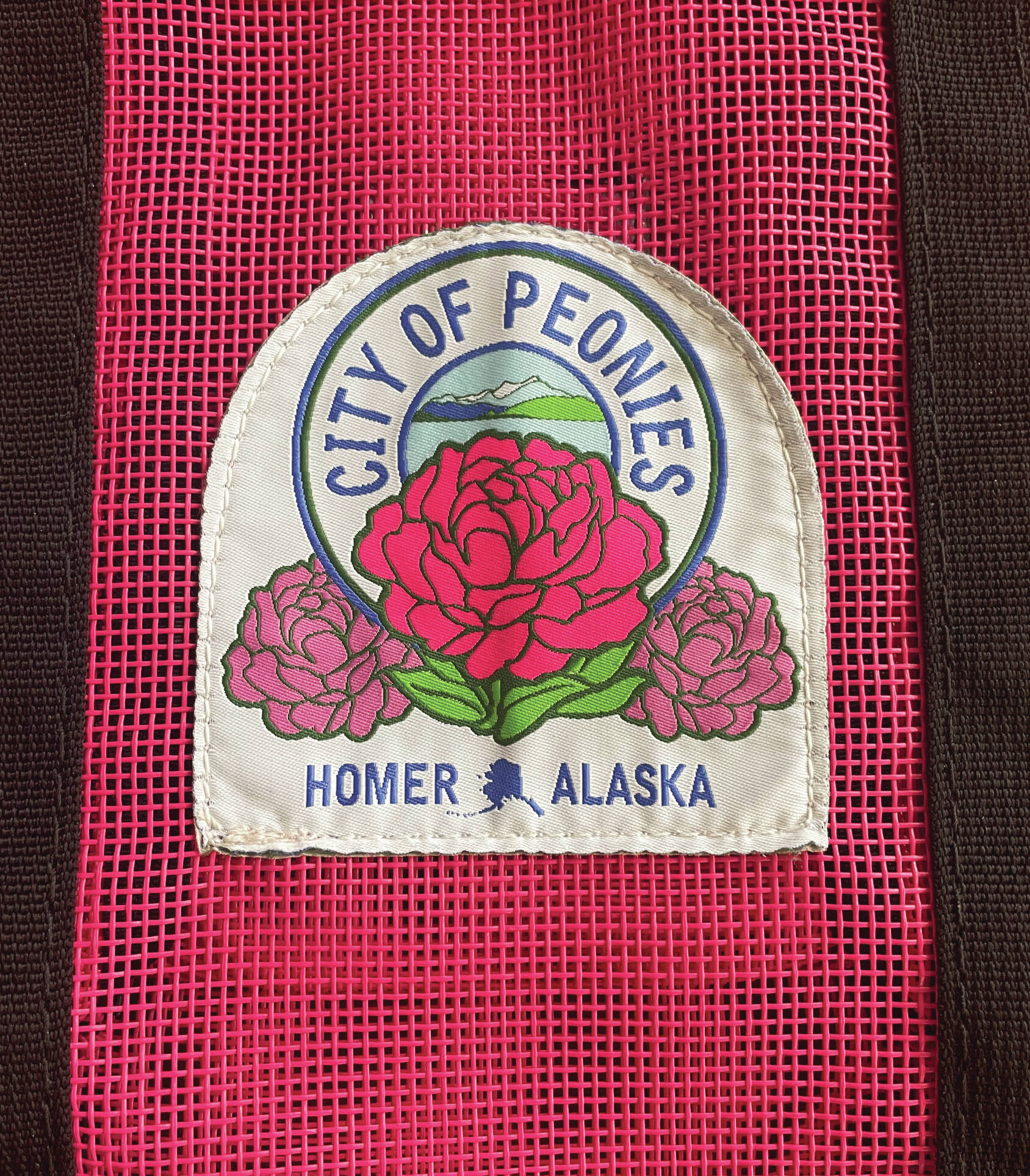 Homer’s official peony patch is attached to a Nomar tote bag, available for purchase at the Homer Chamber of Commerce, during the month of July. (Photo by Emilie Springer/Homer News)