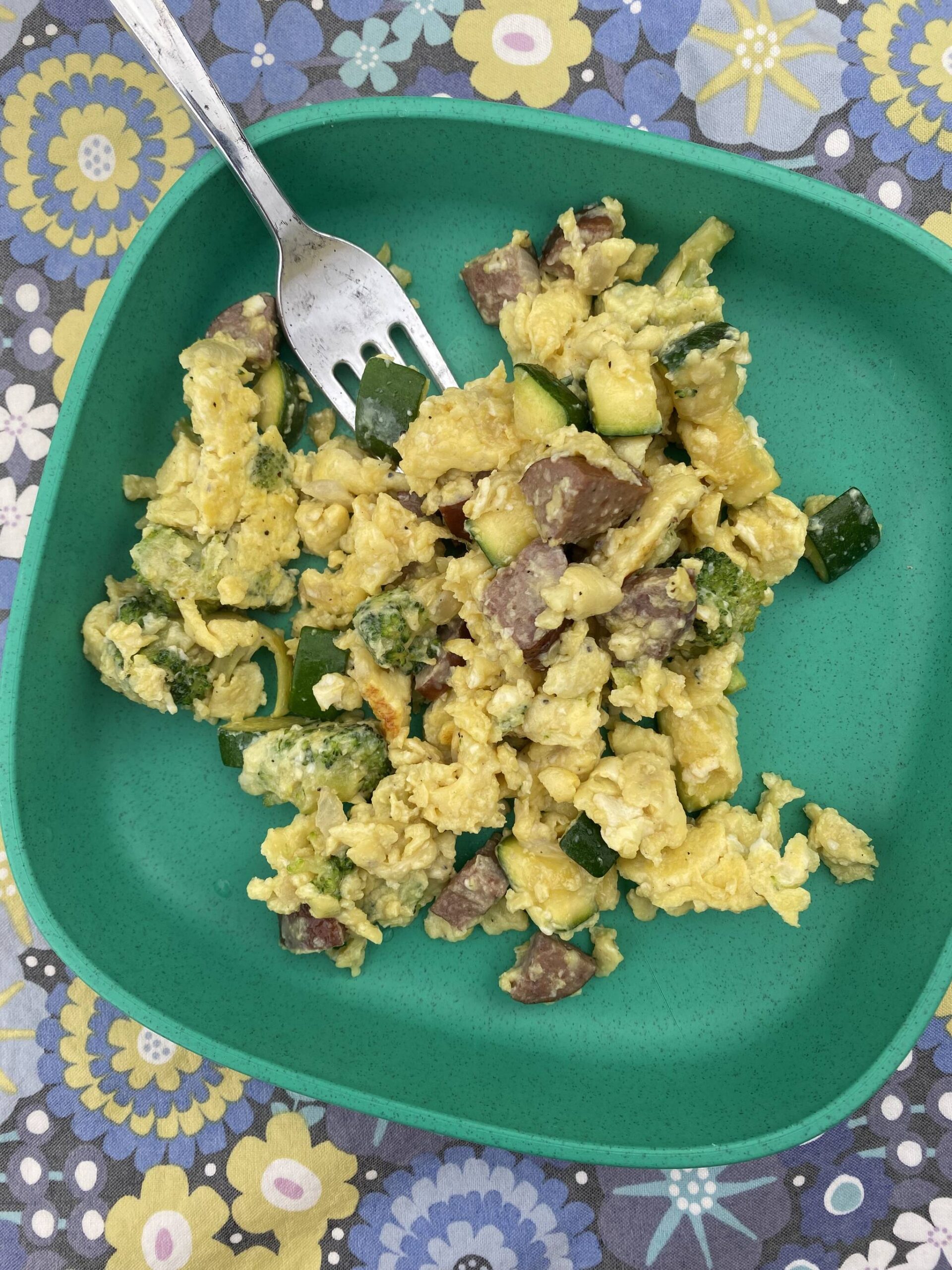 Scrambled eggs with diced zucchini, kielbasa sausage and broccoli florets cooked over a firepit make a hearty and doable outdoors meal. (Photo by Tressa Dale/Peninsula Clarion)
