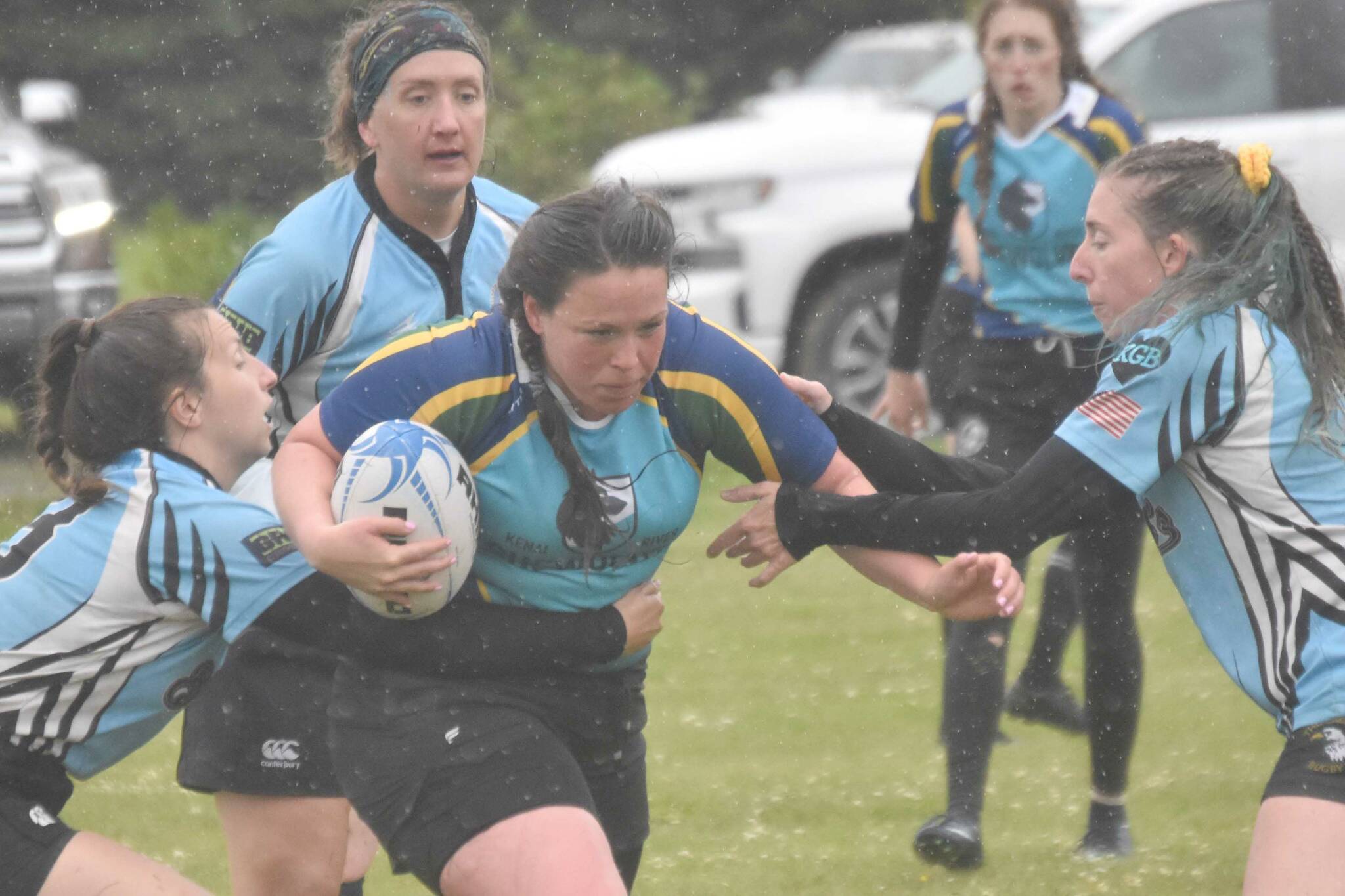 Beth Pokorny, Bonnie Kosten and Loren Schlei of Schylla Rugby try to slow down Ana Reid of the Kenai River SheWolves at the Kenai Dipnet Fest Rugby 10s Tournament on Saturday, July 13, 2024, in Kenai, Alaska. (Photo by Jeff Helminiak/Peninsula Clarion)