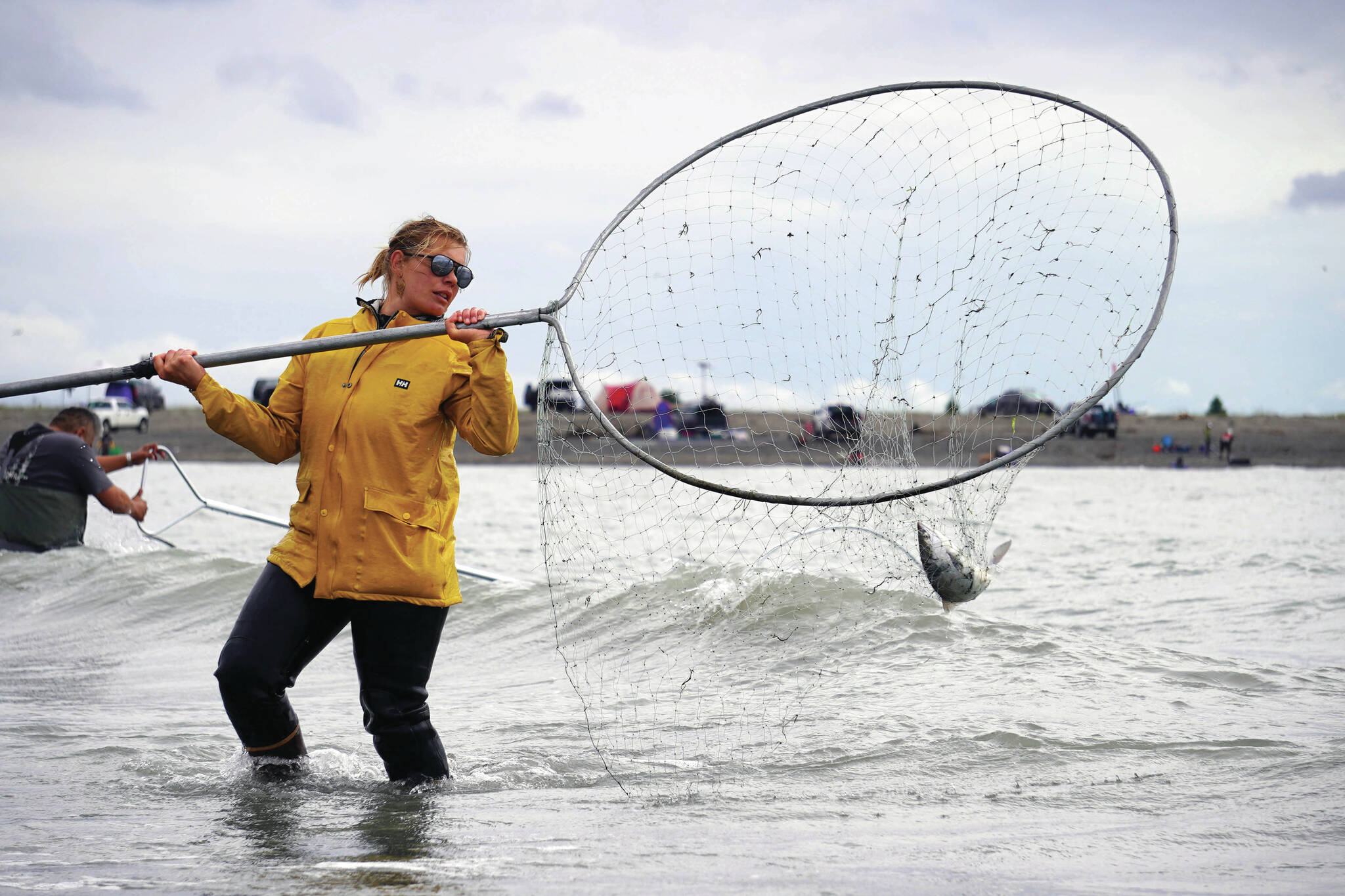 Jake Dye/Peninsula Clarion
Alexis Alamillo, of Anchorage, carries a sockeye salmon caught in a dipnet from the mouth of the Kenai River on Wednesday.