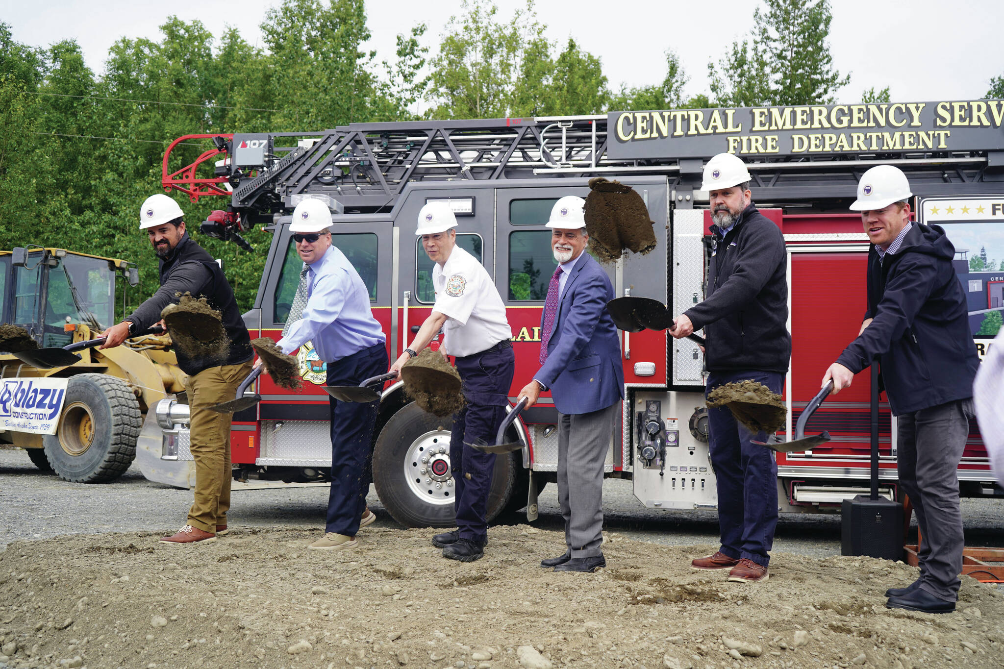 Jake Dye/Peninsula Clarion
Central Emergency Services Chief Roy Browning and other dignitaries toss dirt into the air at a groundbreaking for the new Central Emergency Services Station 1 in Soldotna on Wednesday.