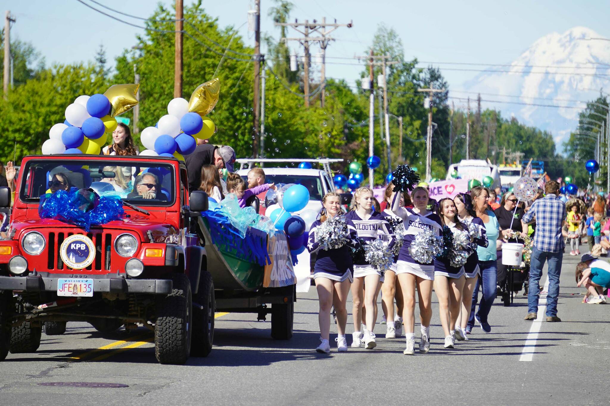 Soldotna High School cheerleaders walk with the Kenai Peninsula Borough Mayor’s Office in 67th Annual Soldotna Progress Days Parade on Marydale Avenue in Soldotna, Alaska, on Saturday, July 27, 2024. (Jake Dye/Peninsula Clarion)