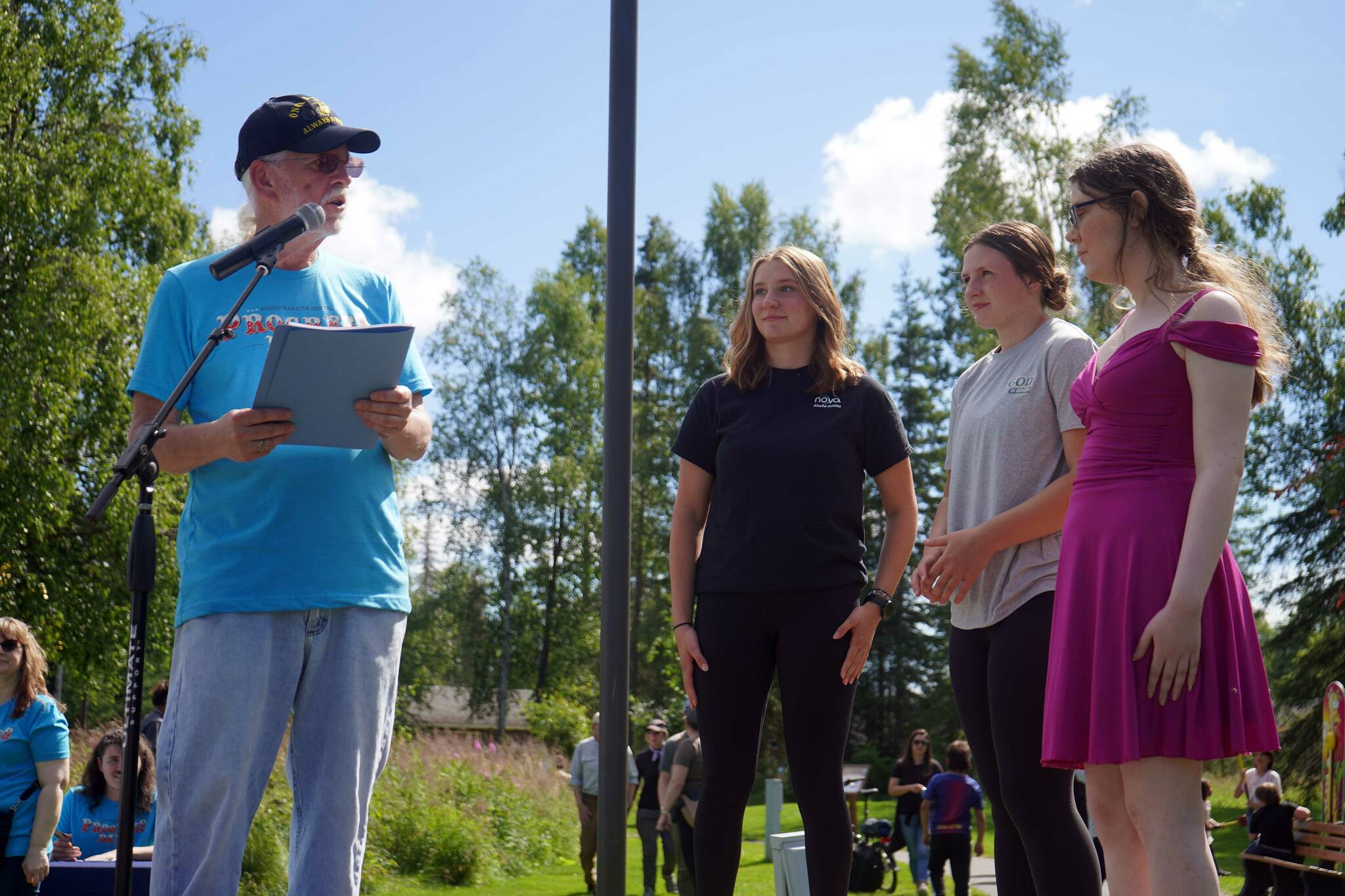 Soldotna Mayor Paul Whitney speaks to the three youth finalists of the City of Soldotna’s “I Voted” Sticker Design Contest at the Soldotna Progress Days Block Party in Parker Park in Soldotna, Alaska, on Saturday, July 27, 2024. (Jake Dye/Peninsula Clarion)