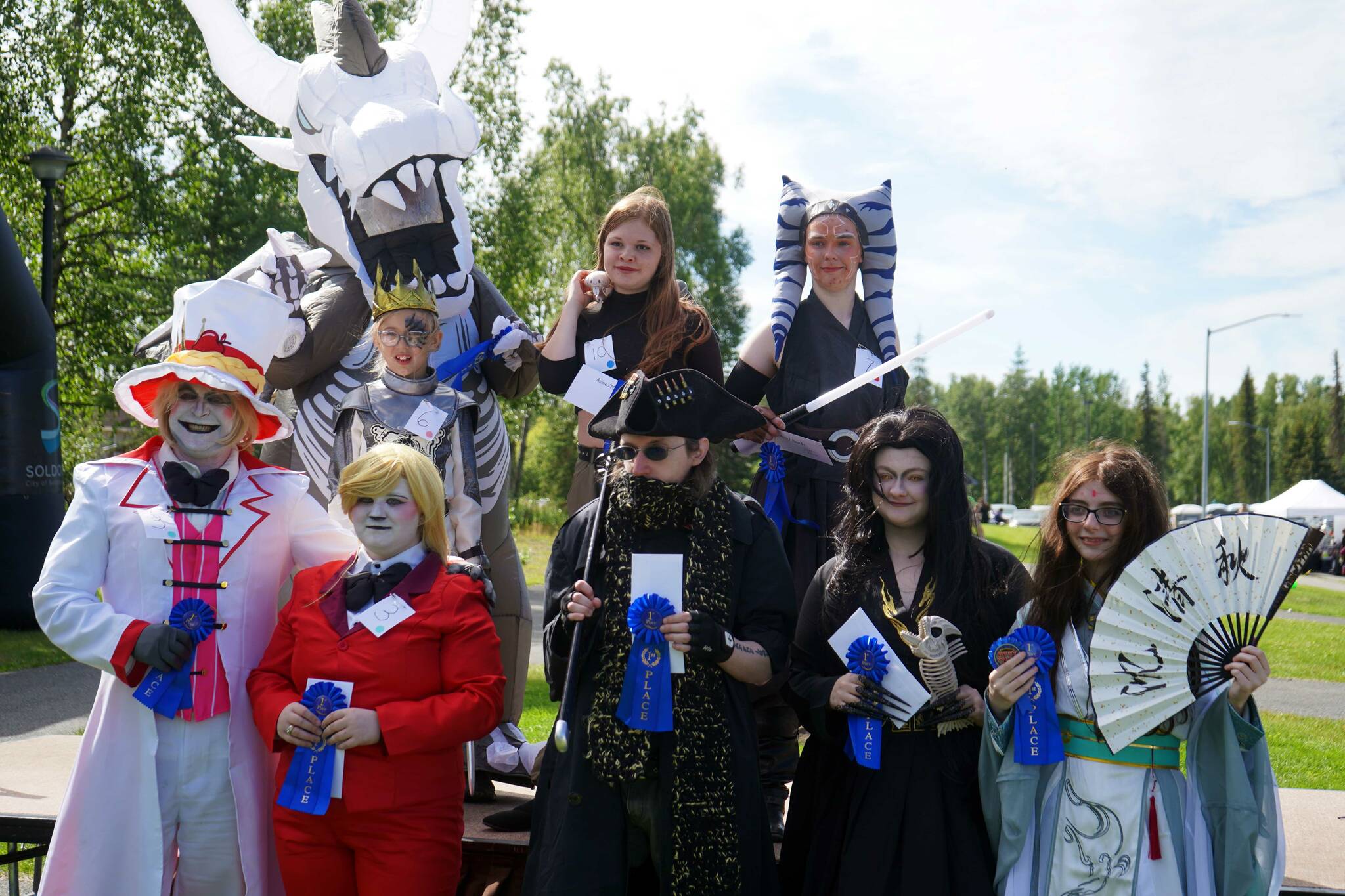 Winners of the Kenai Performers Cosplay Costume Contest stand with their prizes at the Soldotna Progress Days Block Party in Parker Park in Soldotna, Alaska, on Saturday, July 27, 2024. (Jake Dye/Peninsula Clarion)