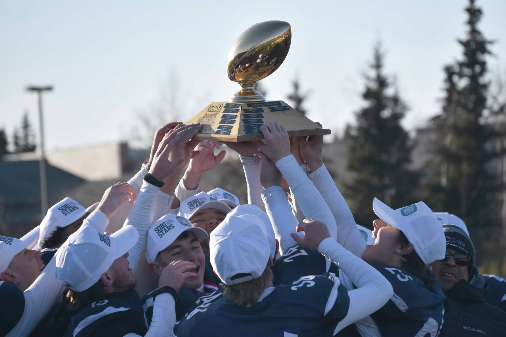 Soldotna hoists the First National Bowl on Saturday, Oct. 21, 2023, after the Division II championship game at Service High School in Anchorage, Alaska. (Photo by Jeff Helminiak/Peninsula Clarion)