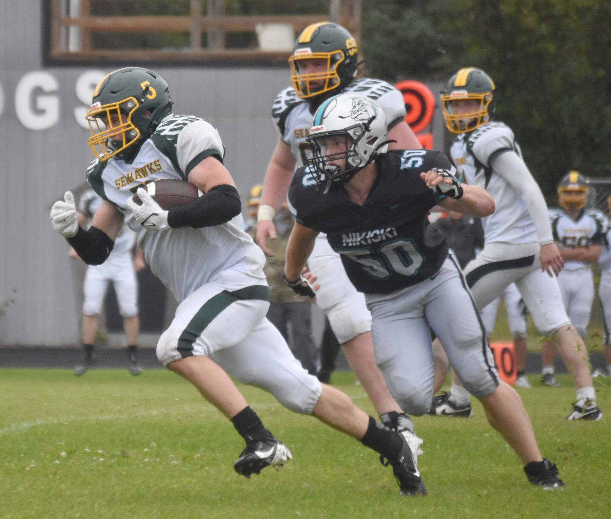 Seward’s Ronan Bickling breaks past Jackson Wittmer and into the open for a touchdown run Saturday, Aug. 17, 2024, at Nikiski Middle-High School in Nikiski, Alaska. (Photo by Jeff Helminiak/Peninsula Clarion)