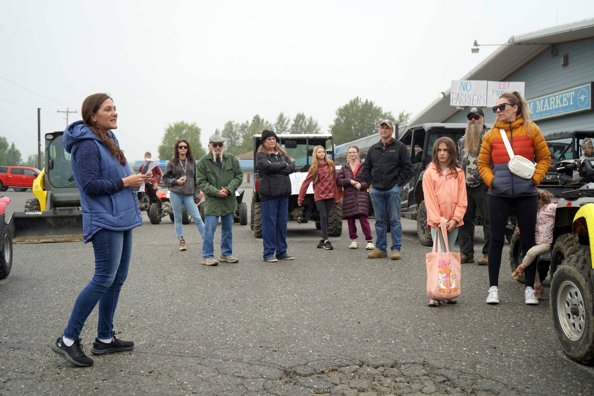 Misty Peterkin speaks moments before the start of the Community Ride for Parking Policy Change outside of M&M Market in Nikiski, Alaska, on Saturday, Aug. 17, 2024. (Jake Dye/Peninsula Clarion)