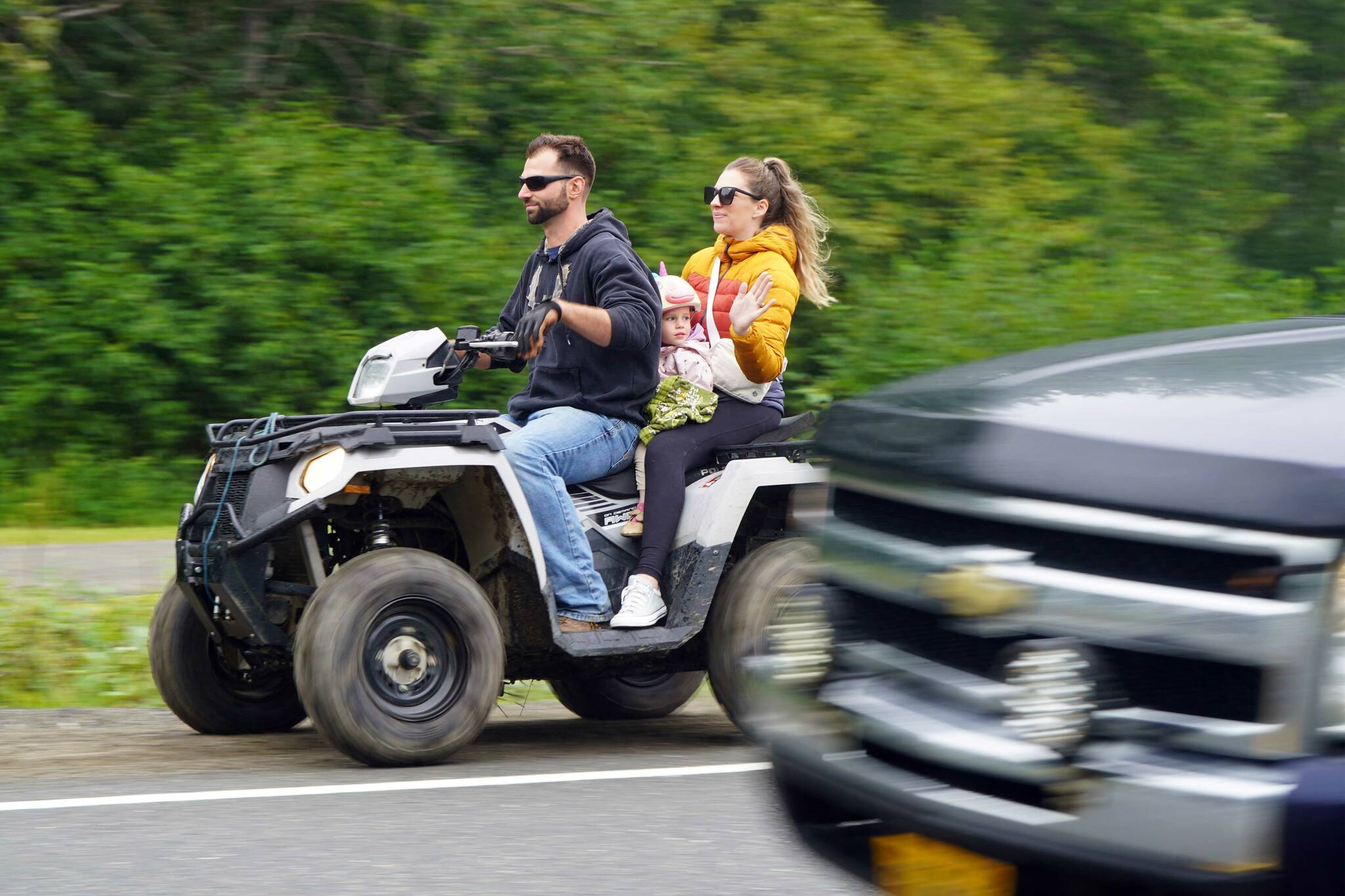 The Community Ride for Parking Policy Change rolls along Nikishka Beach Road in Nikiski, Alaska, on Saturday, Aug. 17, 2024. (Jake Dye/Peninsula Clarion)