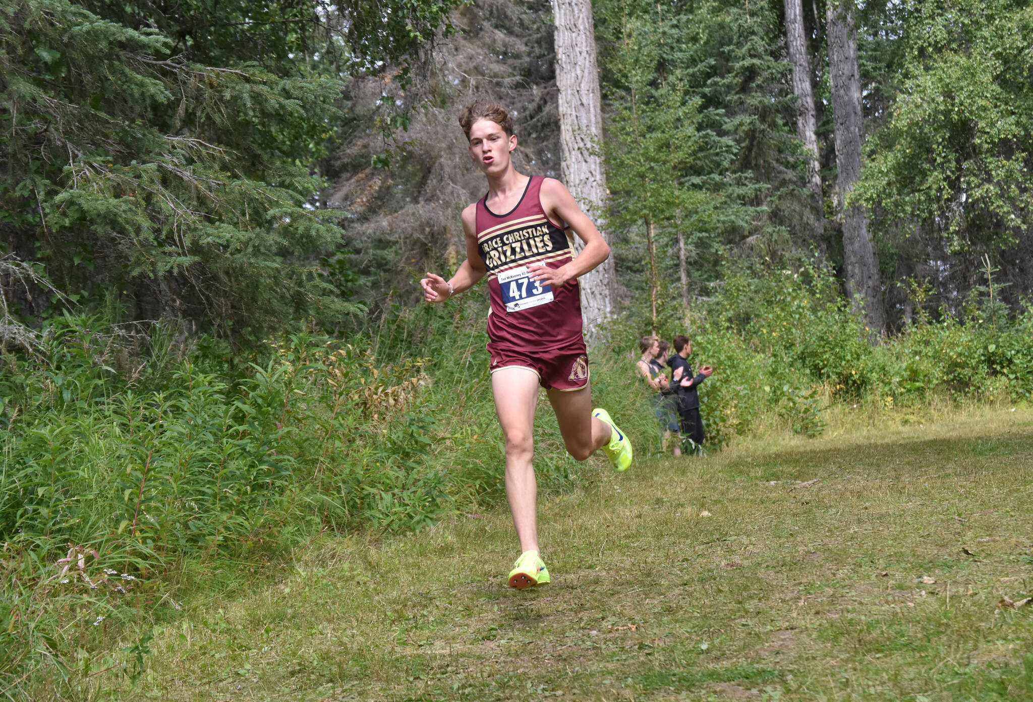 Grace Christian’s Robbie Annett leads the boys varsity race at the Ted McKenney XC Invitational on Saturday, Aug. 24, 2024, at Tsalteshi Trails just outside of Soldotna, Alaska. (Photo by Jeff Helminiak/Peninsula Clarion)