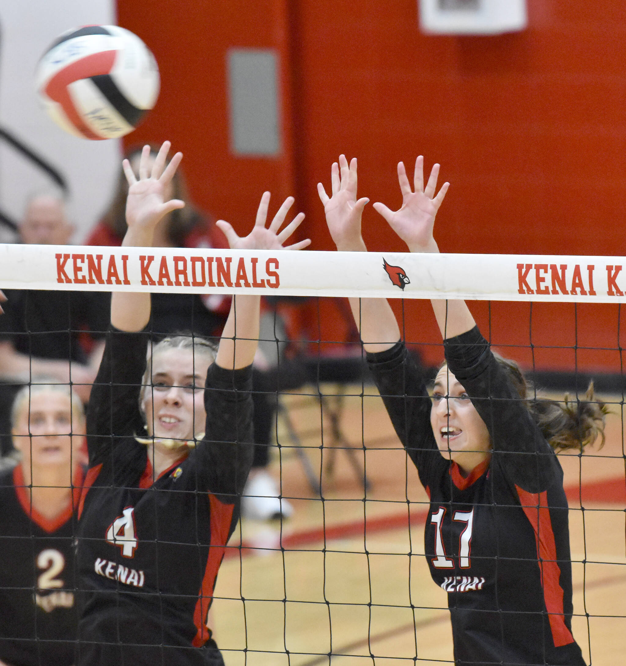 Avia Miller and Sarah Baisden go up for a block against Kodiak at Kenai Central High School in Kenai, Alaska, on Thursday, Aug. 29, 2024. (Photo by Jeff Helminiak/Peninsula Clarion)