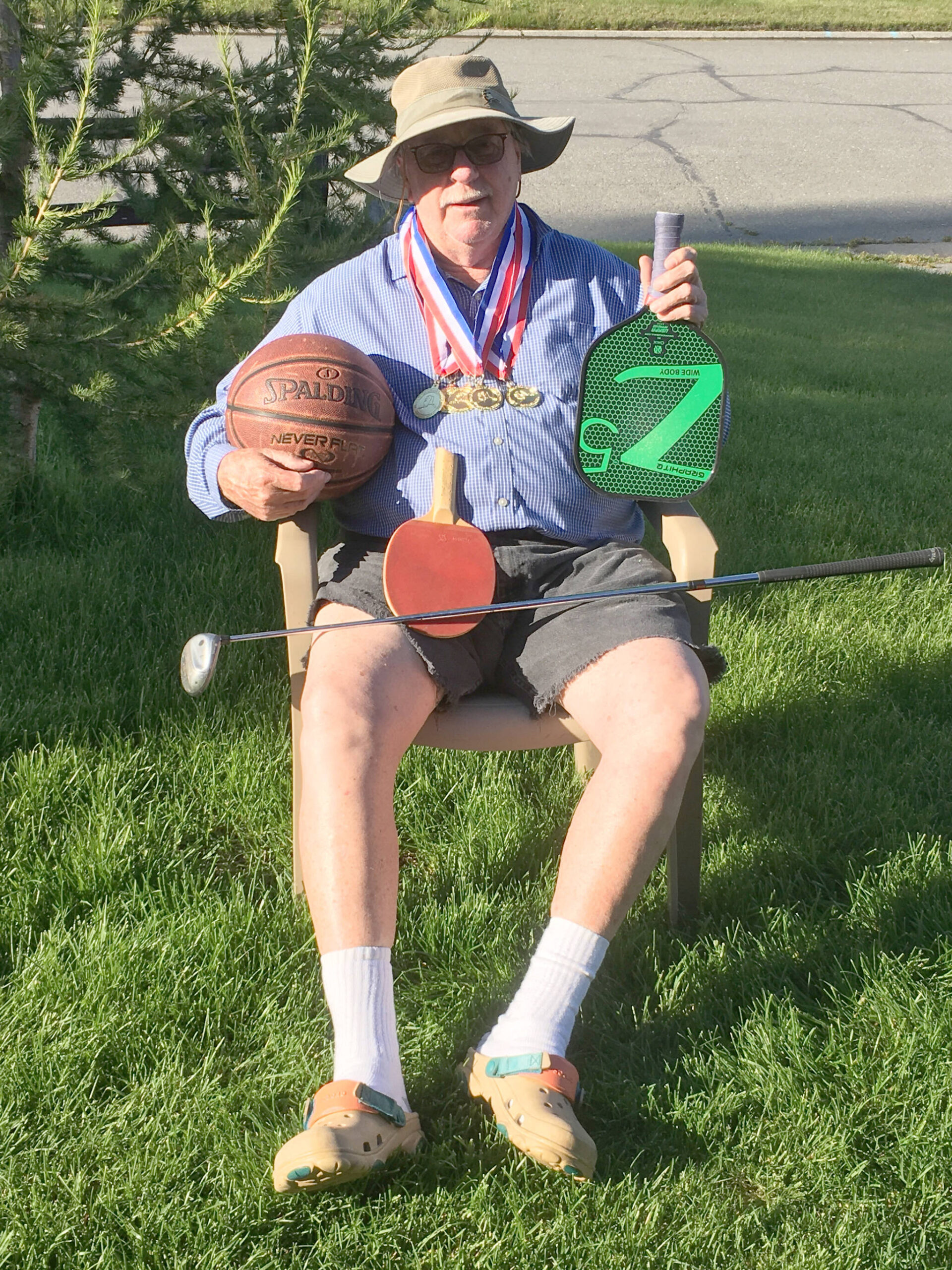 Kenai’s Herman Brad Snead poses with the medals he won, and the things he used to win them, at the Alaska International Senior Games in Fairbanks, Alaska, from Aug. 2 to 11, 2024. (Photo provided)