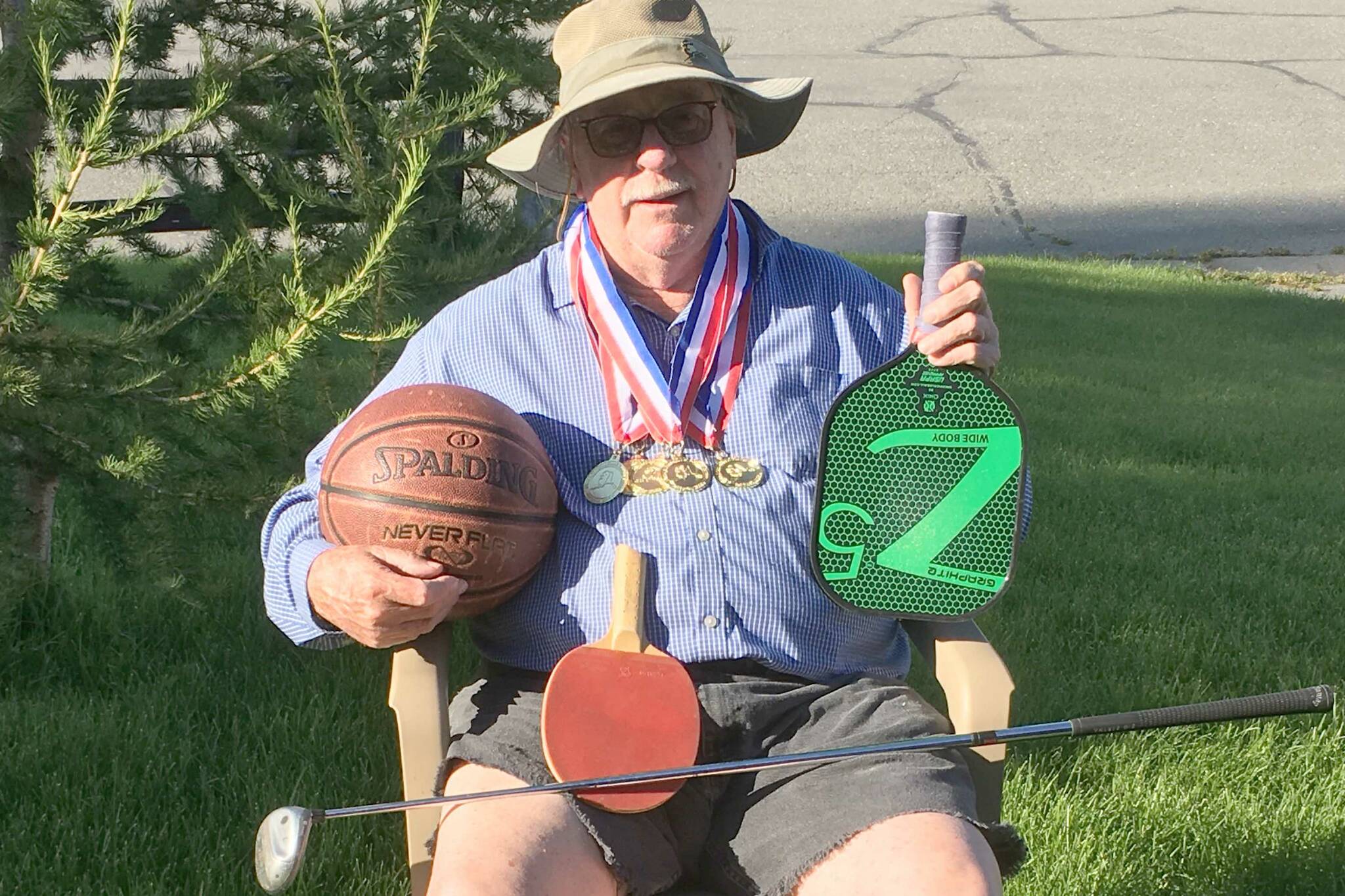 Kenai's Herman Brad Snead poses with the medals he won, and the things he used to win them, at the Alaska International Senior Games in Fairbanks, Alaska, from Aug. 2 to 11, 2024. (Photo provided)