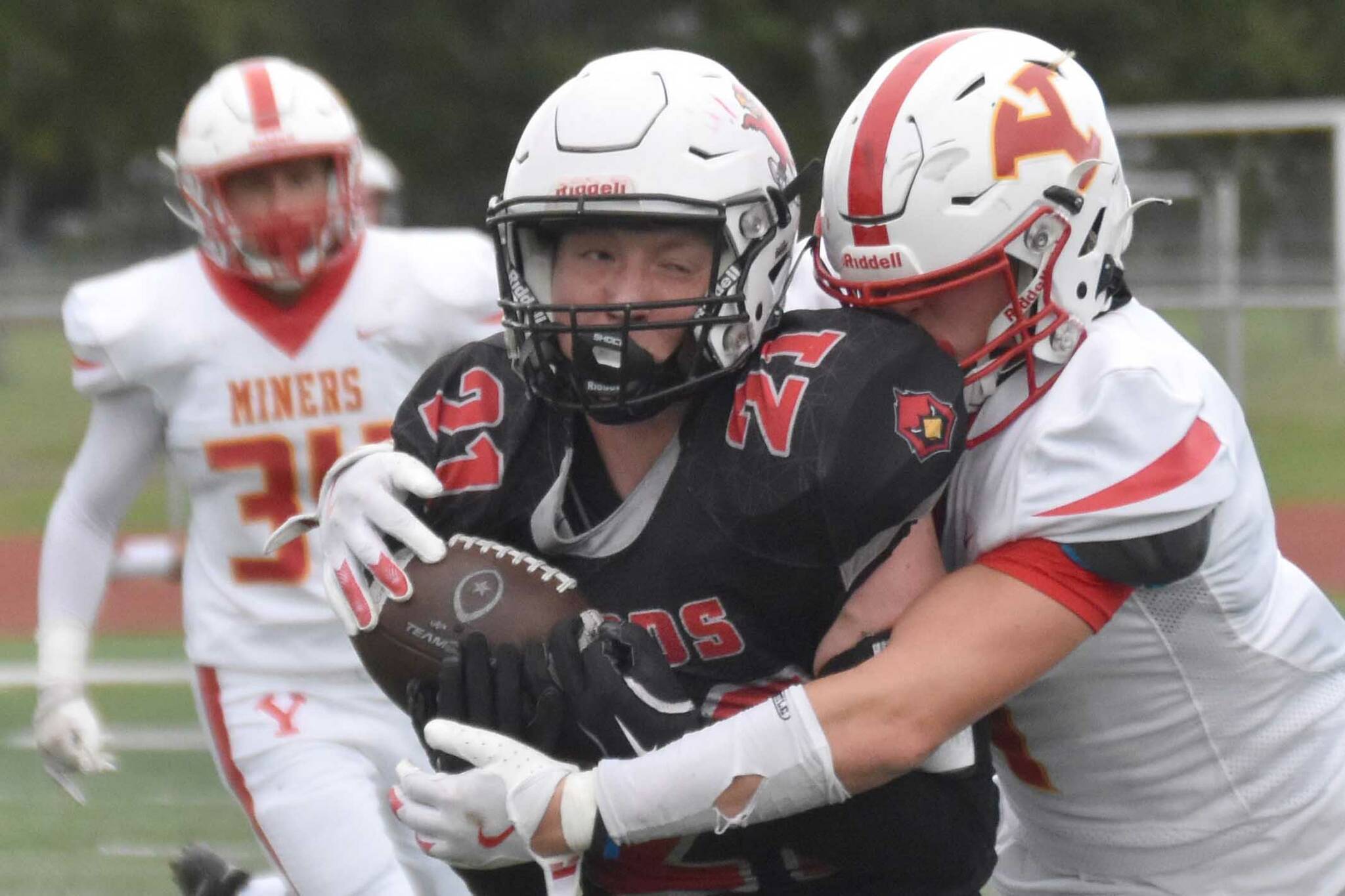 Kenai Central's Hollan Chadwick catches a pass in front of Ryan Warfield of Yreka (California) on Friday, Aug. 30, 2024, at Ed Hollier Field at Kenai Central HIgh School in Kenai, Alaska. (Photo by Jeff Helminiak/Peninsula Clarion)