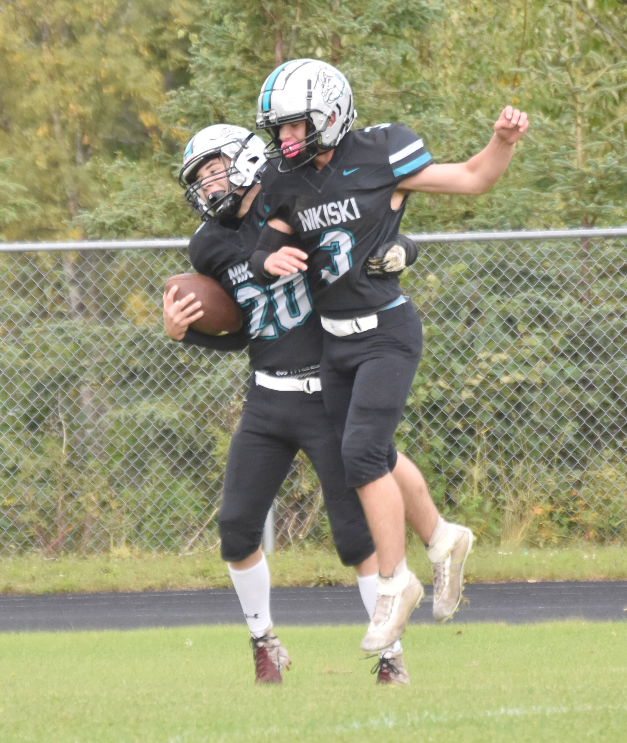 Nikiski’s Wyatt Maguire celebrates his touchdown catch with Kaiden Parrish on Saturday, Aug. 31, 2024, at Nikiski Middle-High School in Nikiski, Alaska. (Photo by Jeff Helminiak/Peninsula Clarion)