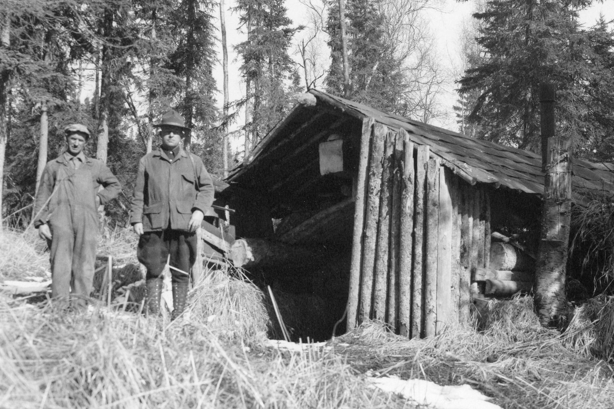 During the brief time (1933-34) that Bob Huttle (right) spent on Tustumena Lake, he documented a tremendous number of structures and described many of the people he met there. One of the men he traveled with frequently was John “Frenchy” Cannon (left), seen here at the Upper Bear Creek Cabin. (Photo courtesy of the Robert Huttle Collection)