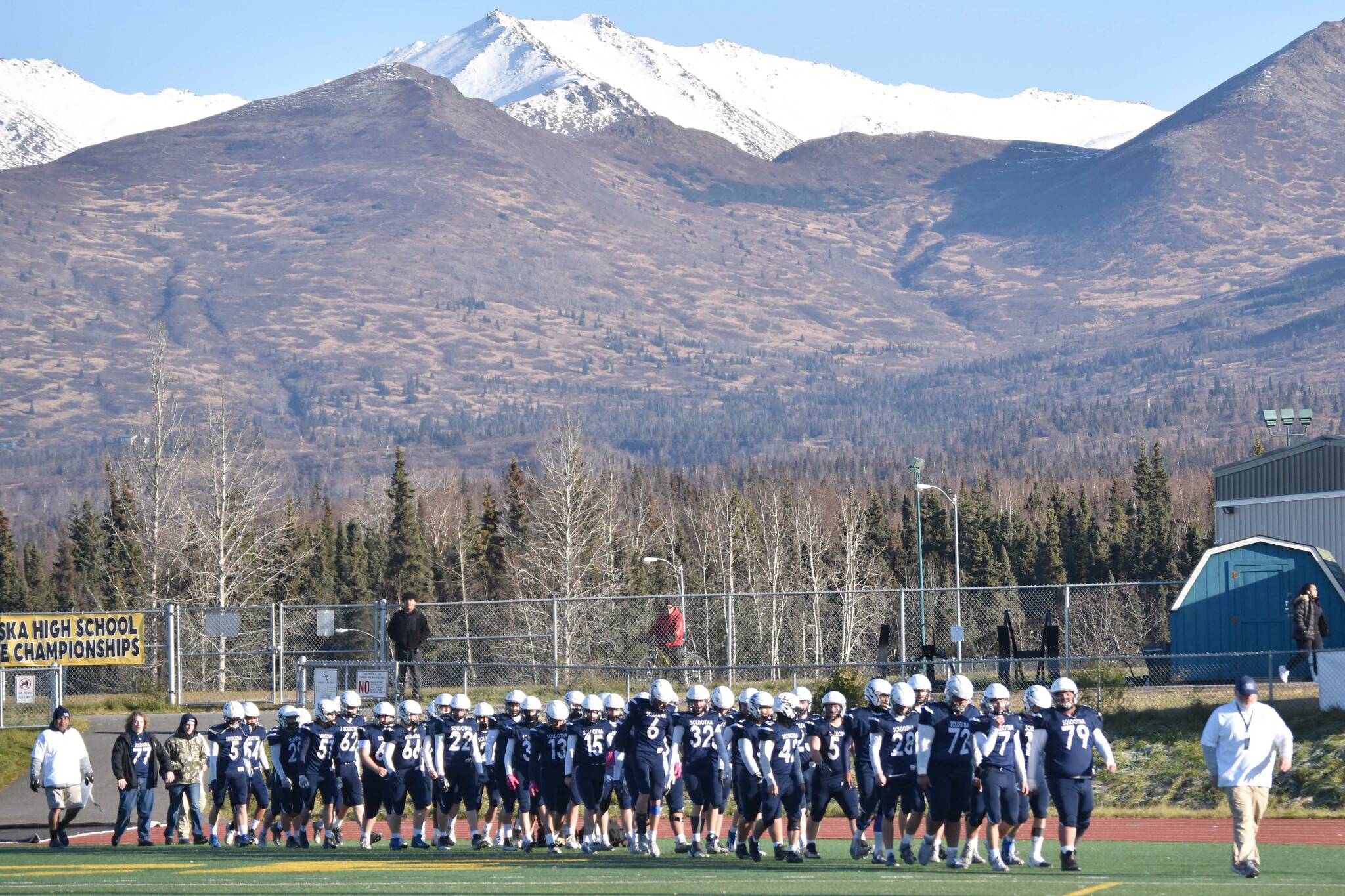 Soldotna head coach Galen Brantley Jr. leads his team back on the field after halftime Saturday, Oct. 21, 2023, in the Division II championship game at Service High School in Anchorage, Alaska. (Photo by Jeff Helminiak/Peninsula Clarion)