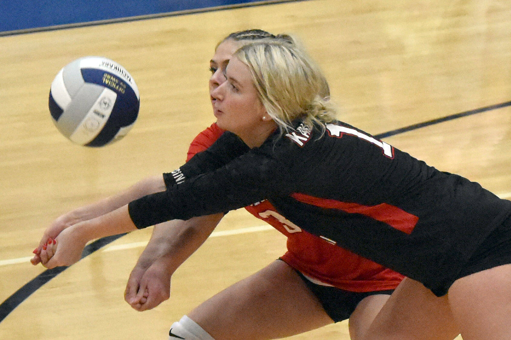 Kenai Central's Brynnen Hansen steps in front of Tait Cooper for a dig Thursday, Sept. 5, 2024, at Soldotna High School in Soldotna, Alaska. (Photo by Jeff Helminiak/Peninsula Clarion)