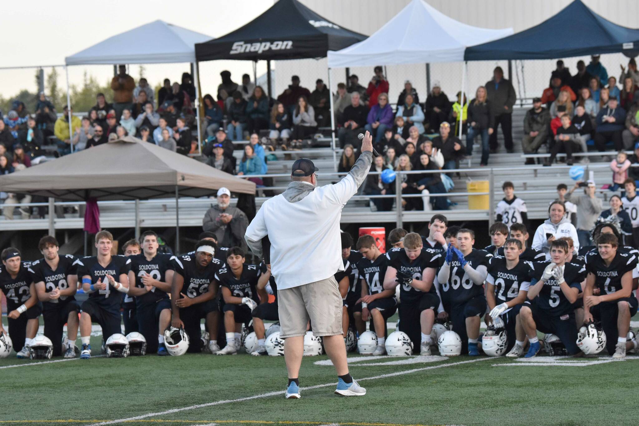 Soldotna head coach Galen Brantley Jr. addresses his team and a homecoming crowd after defeating West Valley 57-21 to roll up the most win by a coach in Alaska history on Friday, Sept. 6, 2024, at Justin Maile Field at Soldotna High School in Soldotna, Alaska. (Photo by Jeff Helminiak/Peninsula Clarion)