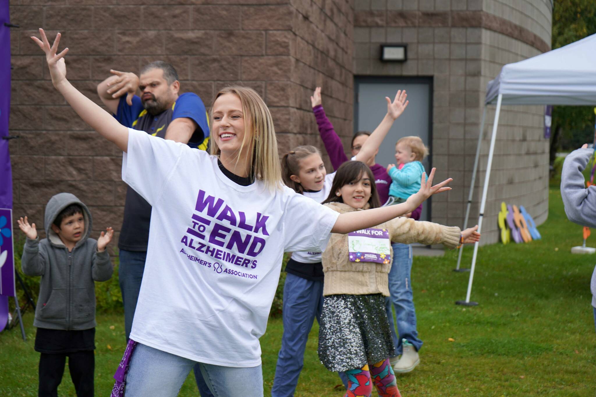 Diamond Dance Project performs alongside people pulled from their audience ahead of the start of the Second Annual Kenai Peninsula Walk to End Alzheimer’s at the Challenger Learning Center of Alaska in Kenai, Alaska, on Saturday, Sept. 7, 2024. (Jake Dye/Peninsula Clarion)