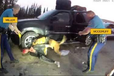 Troopers Joseph Miller Jr. and Jason Woodruff are seen as K9 Olex bites Ben Tikka in a screenshot from body camera footage taken in Kenai, Alaska, on May 24, 2024. (Photo provided by Alaska Department of Law)