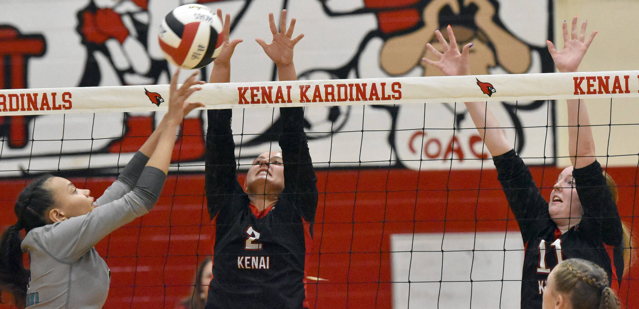 Nikiski’s Alexa Iyatunguk attacks against Kenai’s Central’s Kate Wisnewski and Ellsi Miller on Tuesday, Sept. 10, 2024, at Kenai Central High School in Kenai, Alaska. (Photo by Jeff Helminiak/Peninsula Clarion)