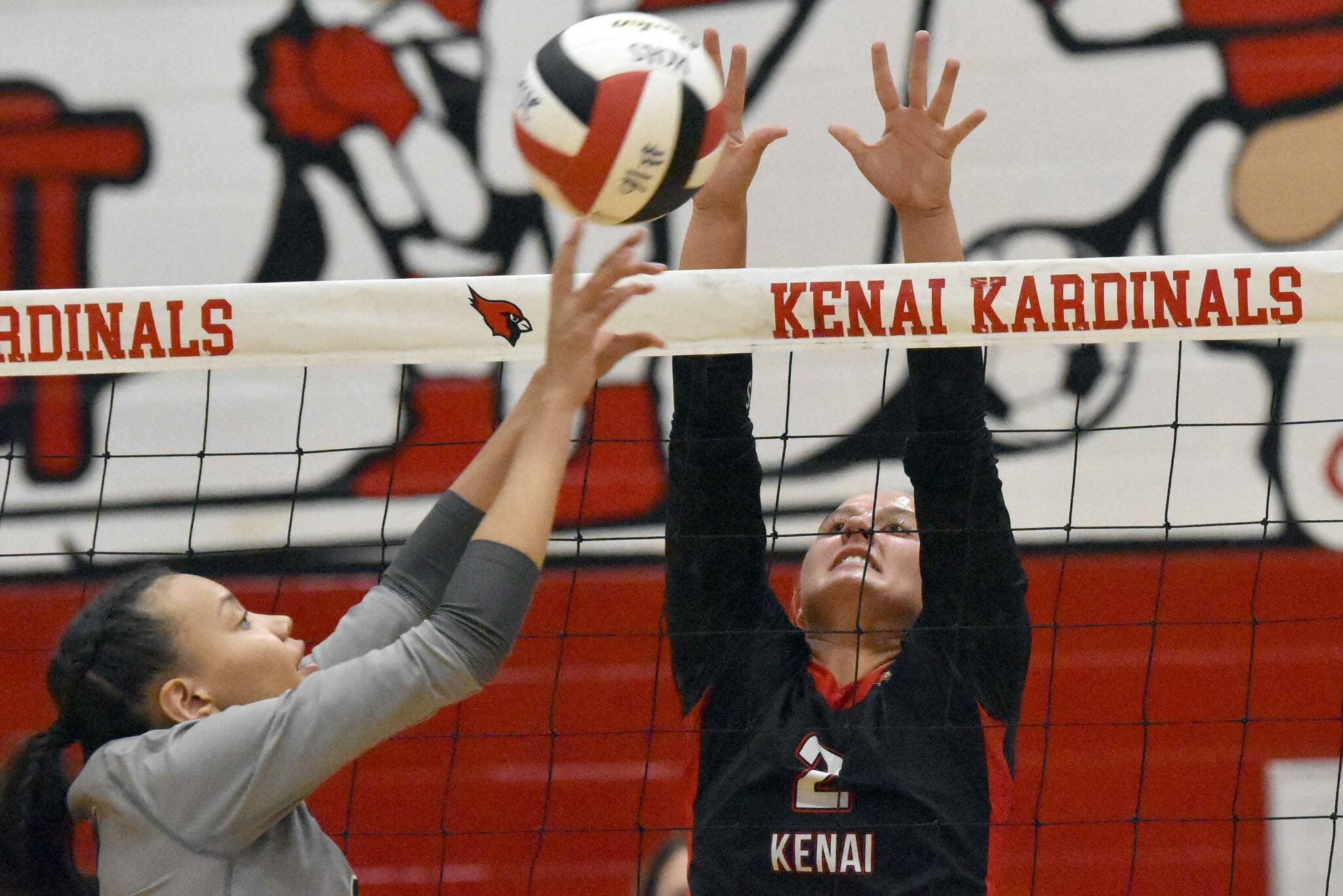 Nikiski's Alexa Iyatunguk attacks against Kenai's Central's Kate Wisnewski and Ellsi Miller on Tuesday, Sept. 10, 2024, at Kenai Central High School in Kenai, Alaska. (Photo by Jeff Helminiak/Peninsula Clarion)