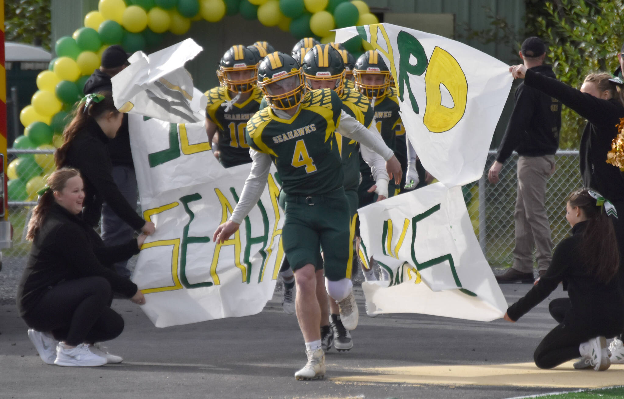 Seward quarterback Brett Gilmore leads his team onto the field Friday, Sept. 13, 2024, at Roger Steinbrecher Memorial Field in Seward, Alaska. (Photo by Jeff Helminiak/Peninsula Clarion)