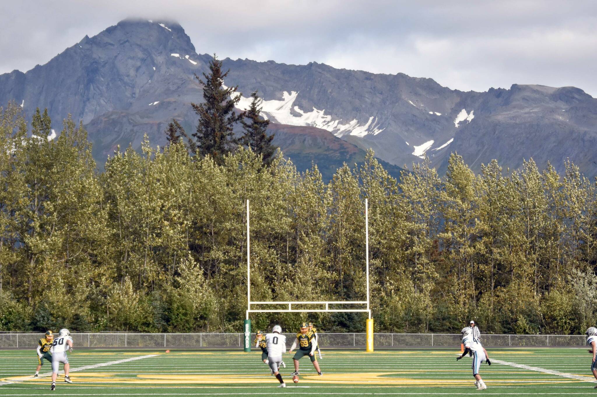 Nikiski's Oliver Parrish puts the ball in play for the first time on the new artificial turf Friday, Sept. 13, 2024, at Roger Steinbrecher Memorial Field in Seward, Alaska. (Photo by Jeff Helminiak/Peninsula Clarion)