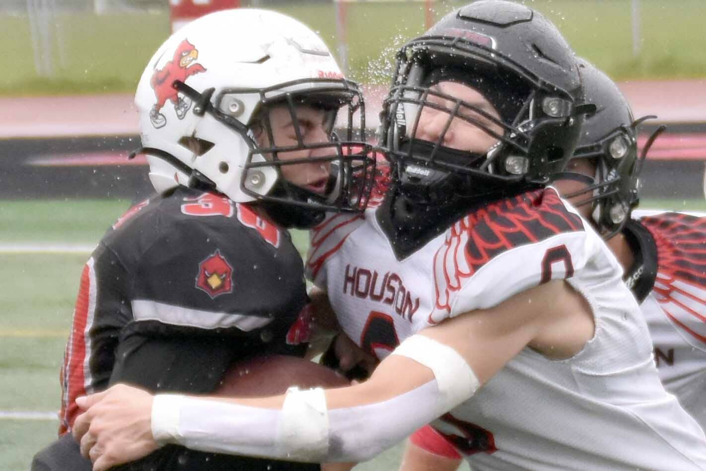 Kenai Central's Cole Langham is tackled by Houston's Elias Johnson on Saturday, Sept. 14, 2024, at Ed Hollier Field at Kenai Central High School in Kenai, Alaska. (Photo by Jeff Helminiak/Peninsula Clarion)