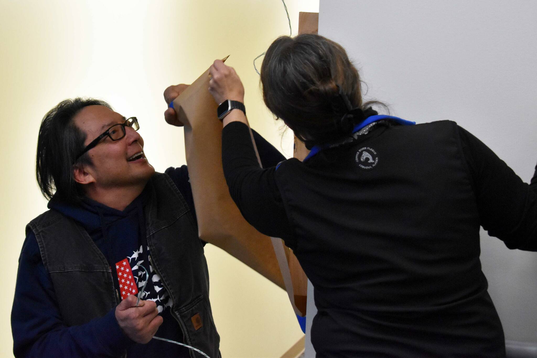 Kenai Peninsula College Associate Professor of Art Cambid-J “Cam” Choy unveils a piece of art he made to commemorate the Alan ‘Tiqutsex’ Boraas Anthropology Lab at Kenai Peninsula College in Soldotna, Alaska, on Friday, Sept. 16, 2022. (Jake Dye/Peninsula Clarion)