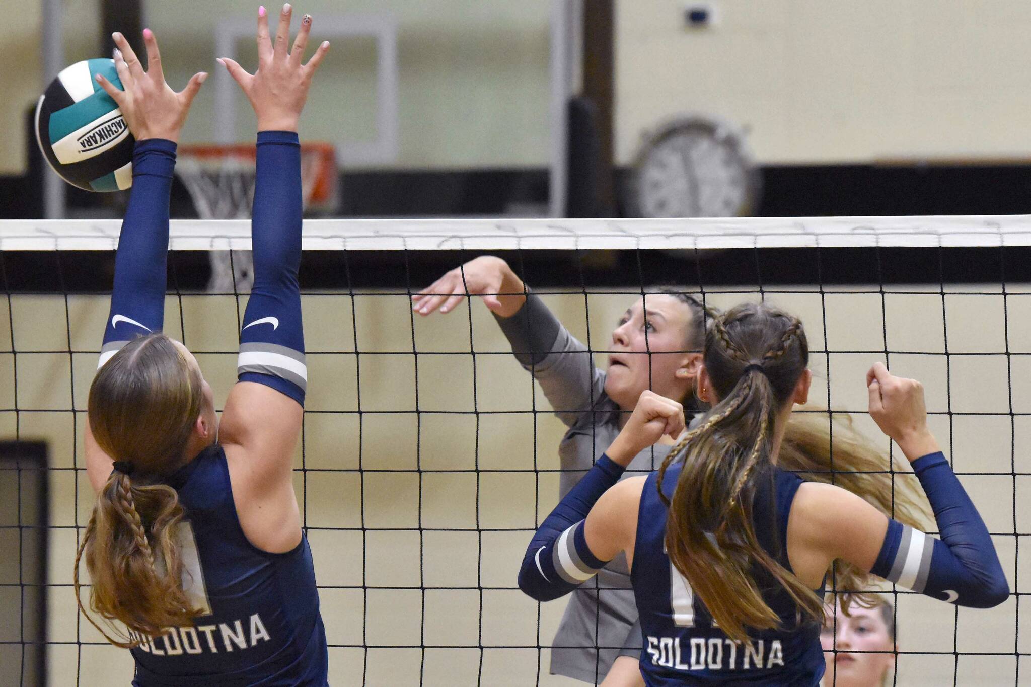 Nikiski's Mandee Roofe attacks against Soldotna's Sadie Lane and Hallie Fischer on Thursday, Sept. 19, 2024, at Nikiski Middle-High School in Nikiski, Alaska. (Photo by Jeff Helminiak/Peninsula Clarion)