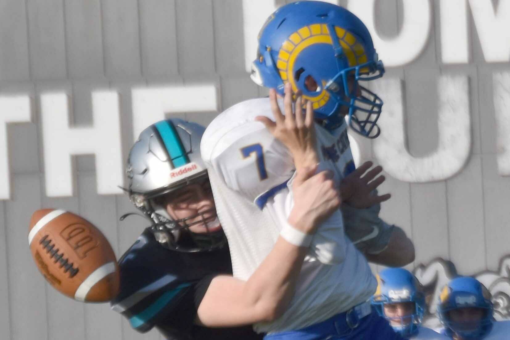 Nikiski's Kevin Love forces a fumble from Monroe Catholic quarterback Ryan Mavencamp on Friday, Sept. 20, 2024, at Nikiski Middle-High School in Nikiski, Alaska. (Photo by Jeff Helminiak/Peninsula Clarion)