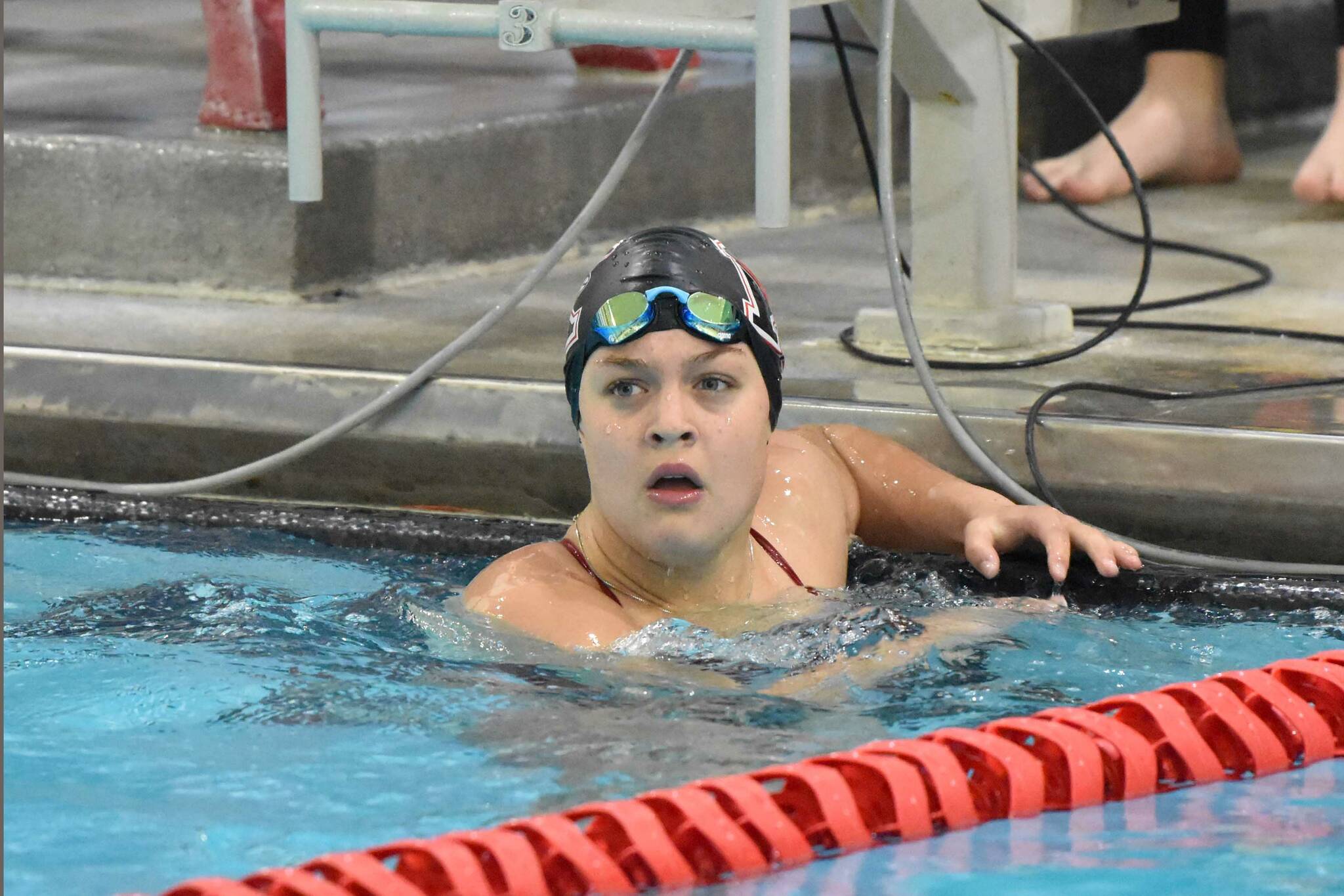 Kenai Central's Abigail Price finishes the anchor leg in the 400-yard freestyle relay at the Kenai Invitational on Saturday, Sept. 21, 2024, at Kenai Central High School in Kenai, Alaska. (Photo by Jeff Helminiak/Peninsula Clarion)