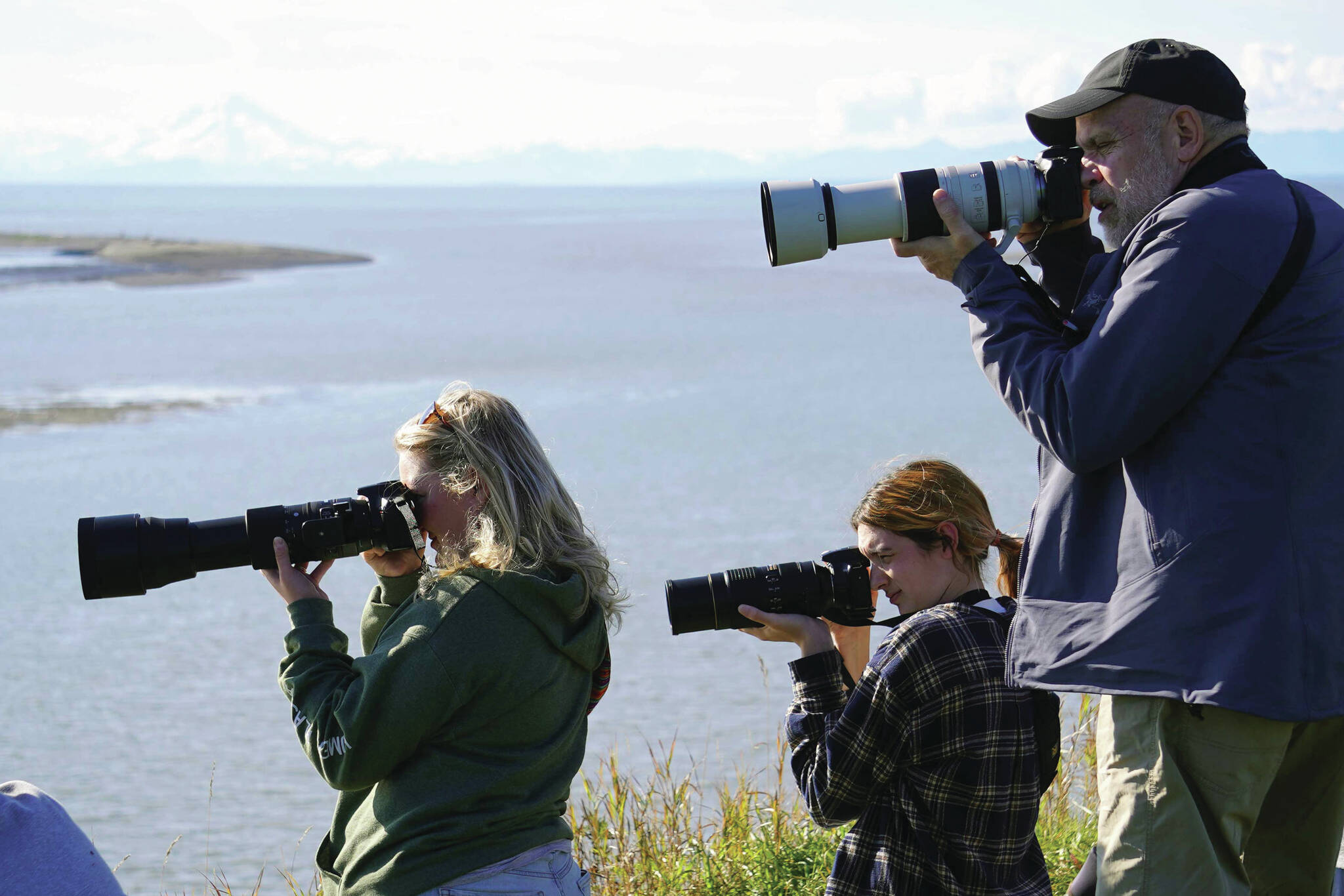 Jake Dye/Peninsula Clarion
Attendees seek out endangered Cook Inlet belugas during Belugas Count! on the bluff above the Kenai River in Kenai on Saturday.