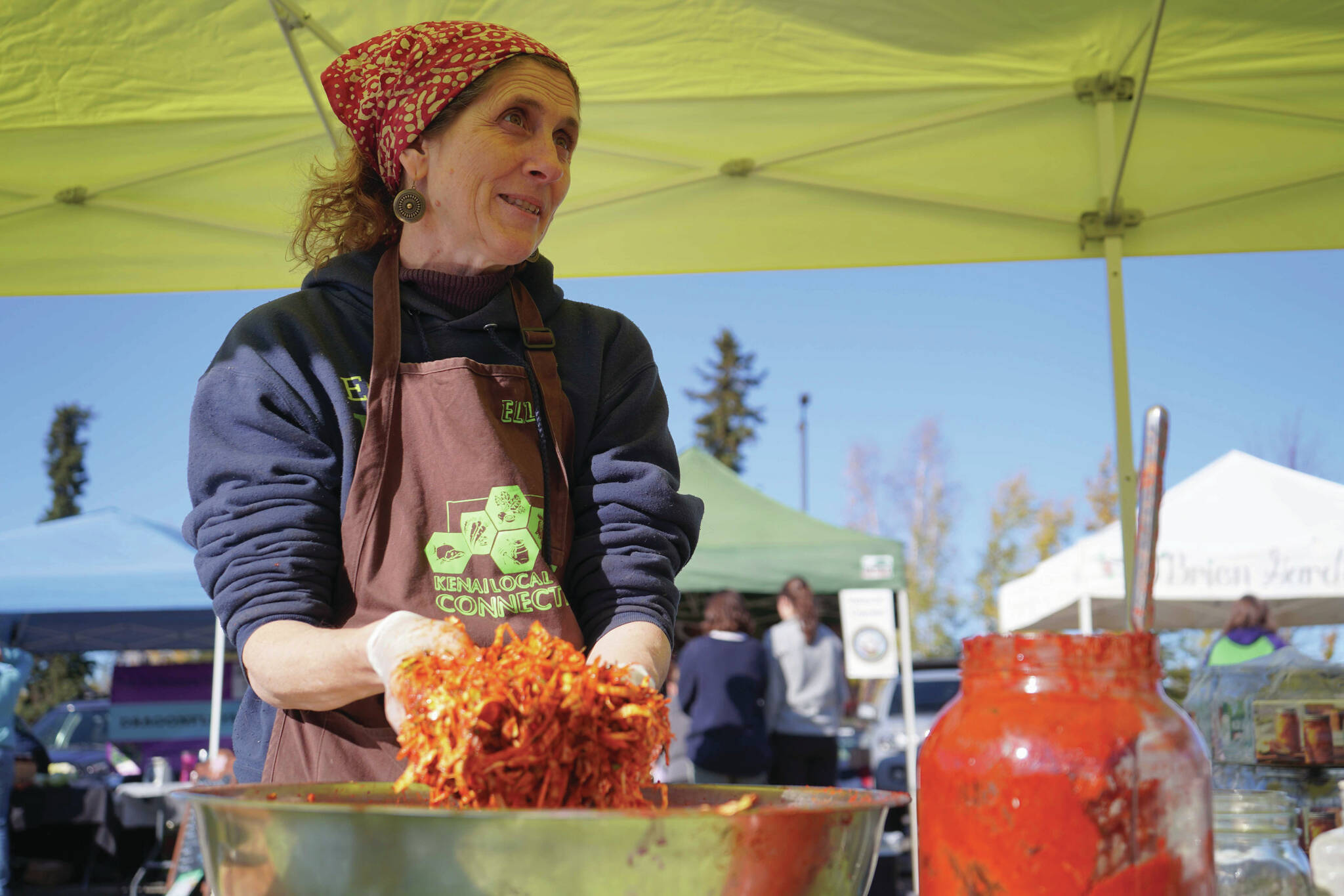 Jake Dye/Peninsula Clarion
A presenter processes cabbage for storage at the fermentation station during the Harvest Moon Local Food Festival at Soldotna Creek Park on Saturday.