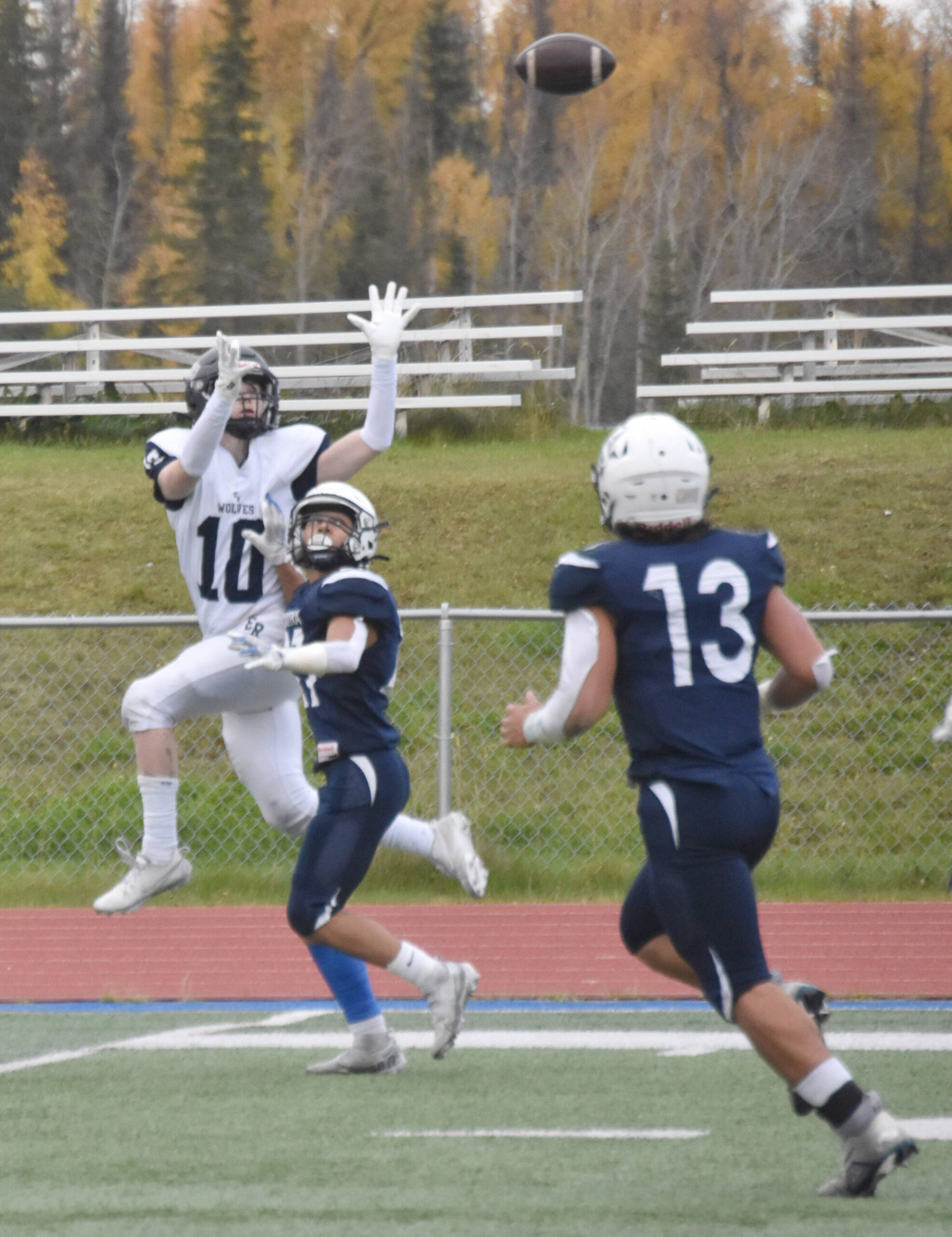 Eagle River’s David Shipley goes up for a pass against Soldotna’s Mason Bock on Friday, Sept. 27, 2024, at Justin Maile Field at Soldotna High School in Soldotna, Alaska. Bock was able to knock the ball away. (Photo by Jeff Helminiak/Peninsula Clarion)