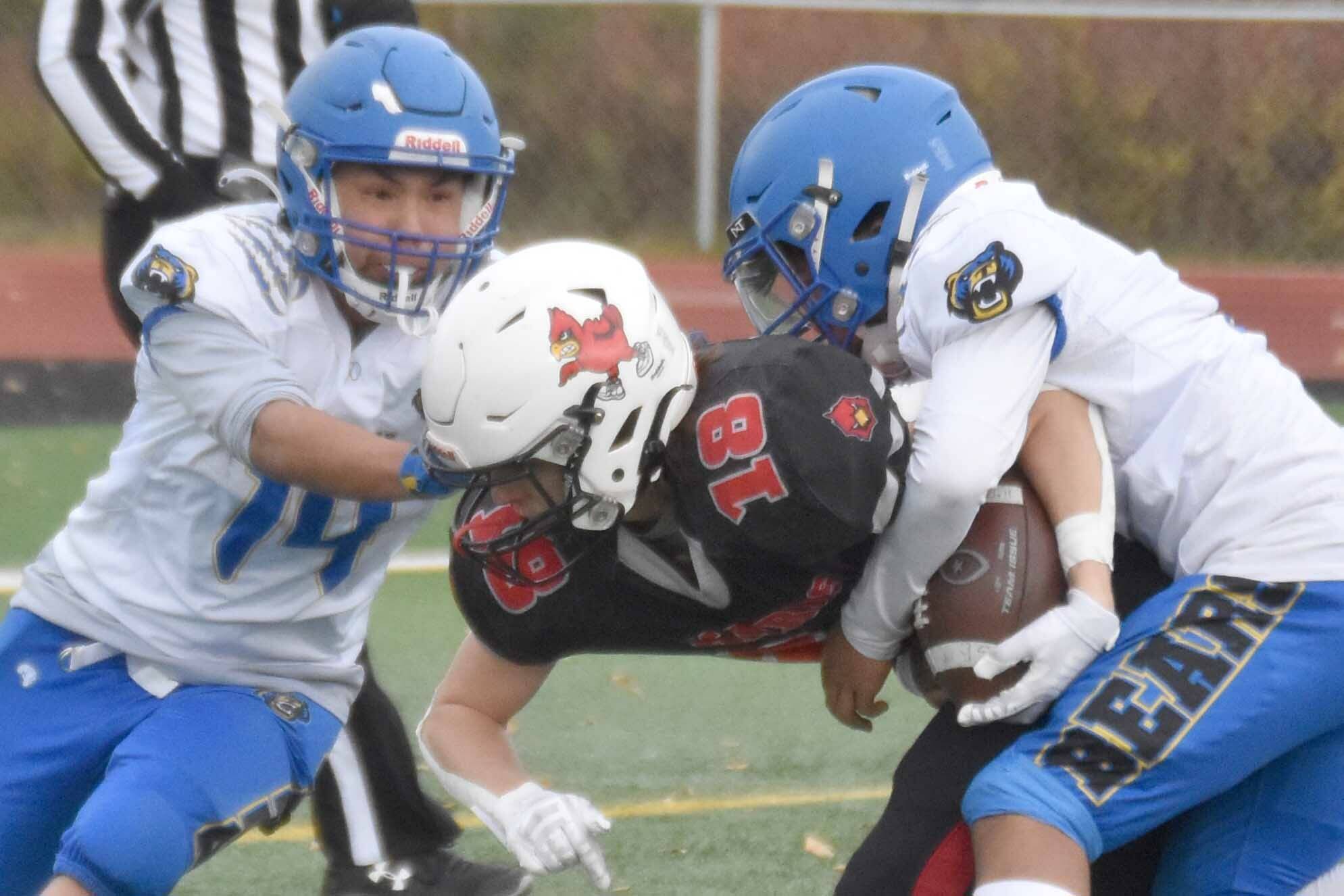 Kenai Central's Aasen Campanella plows through Kodiak's Gavin Peterson and Victoriano Sorio for a touchdown Saturday, Sept. 28, 2024, at Ed Hollier Field at Kenai Central High School in Kenai, Alaska. (Photo by Jeff Helminiak/Peninsula Clarion)