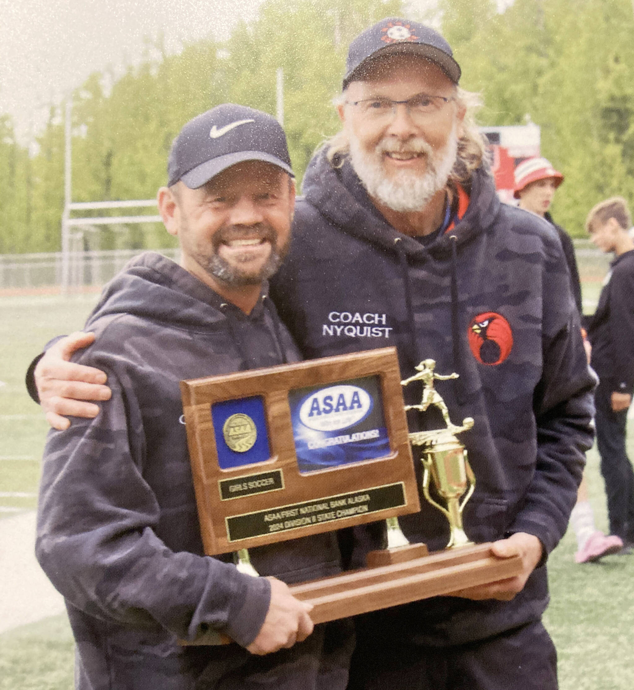 Kenai Central head coach Dan Verkuilen and assistant Brad Nyquist celebrate winning the Division II girls state soccer title Saturday, May 25, 2024, in Wasilla, Alaska. (Photo provided)