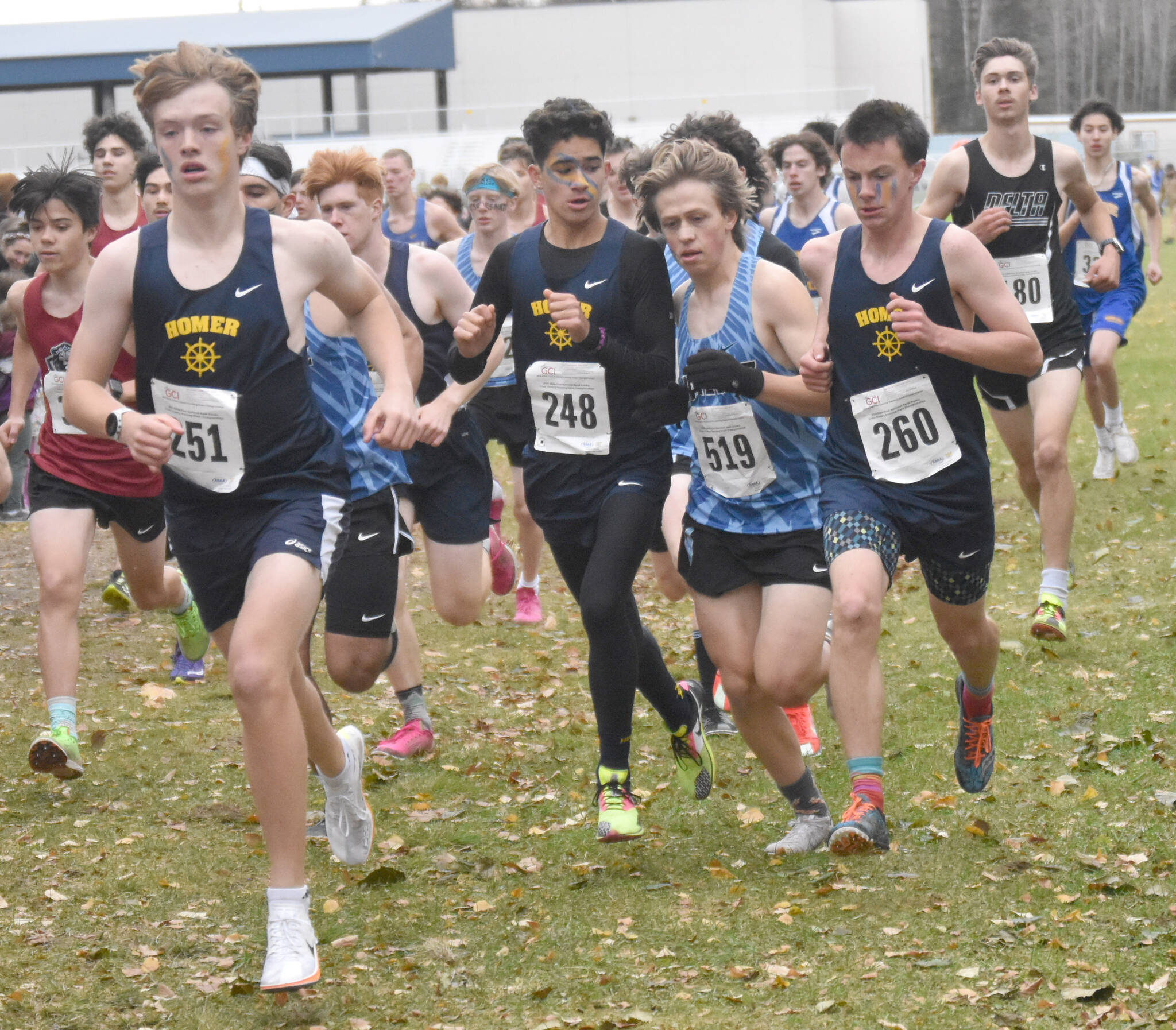 Homer’s Caleb Bunker leads the way as Valdez’s Reggie Baksis races between Homer’s Jai Badajos and Reid Rauch in the Division II boys race at the state cross-country running meet on Saturday, Oct. 5, 2024, at Bartlett High School in Anchorage, Alaska. (Photo by Jeff Helminiak/Peninsula Clarion)