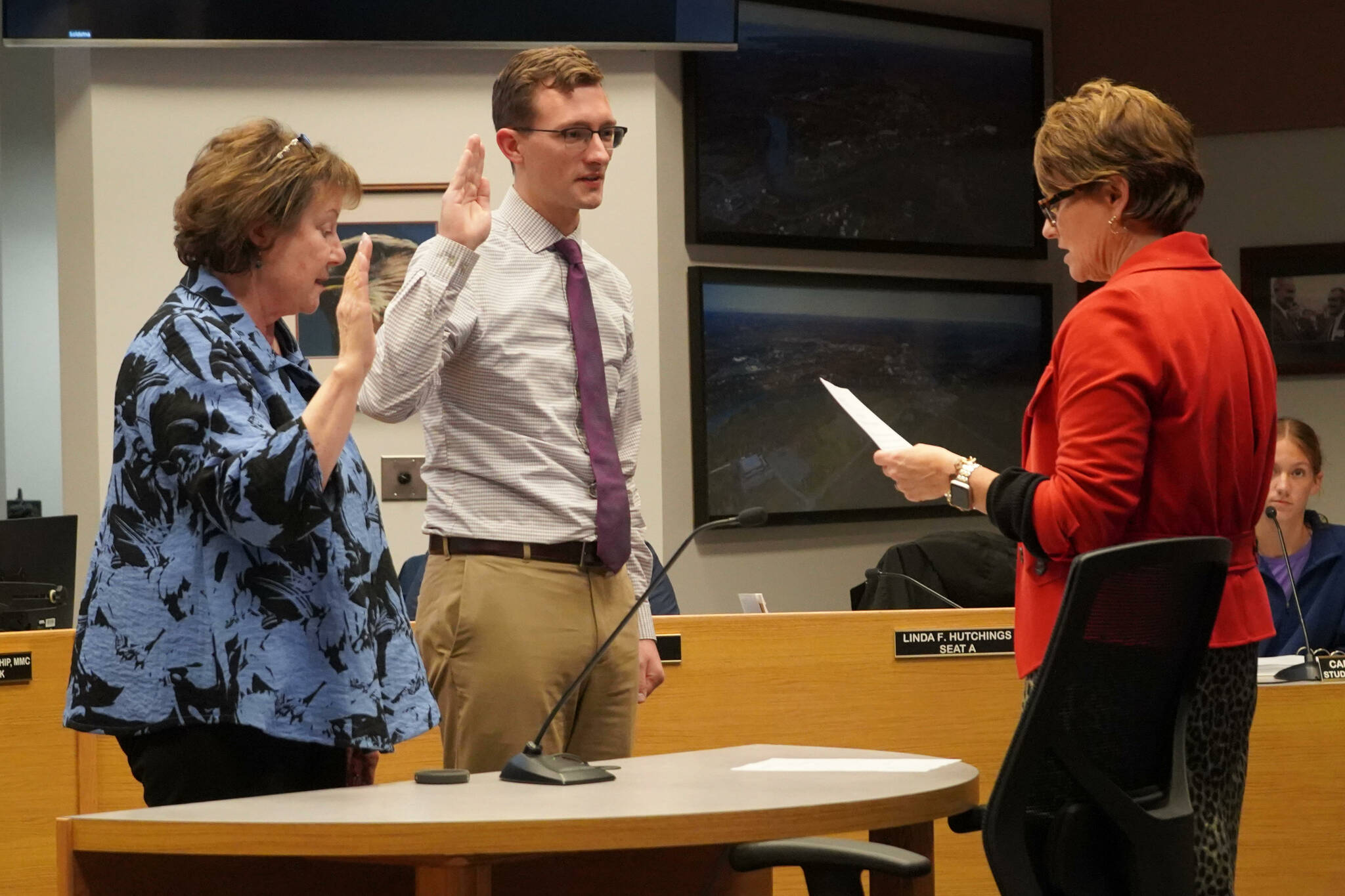 Soldotna City Clerk Johni Blankenship, right, administers oaths of office to Linda Farnsworth-Hutchings and Jordan Chilson during a meeting of the Soldotna City Council in Soldotna, Alaska, on Wednesday, Oct. 9, 2024. (Jake Dye/Peninsula Clarion)