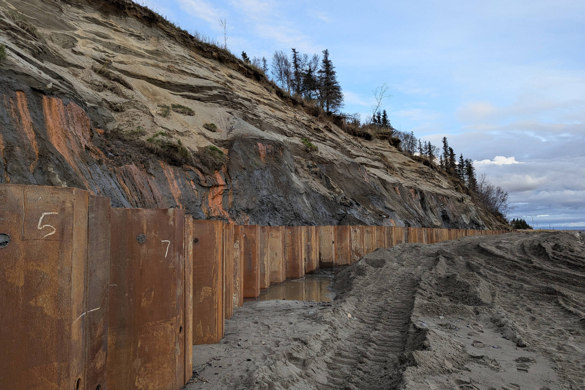 Metal reinforcements line the front of the Kenai Bluff at North Kenai Beach, Tuesday, Oct. 8, 2024, in Kenai, Alaska. (Photo by Erin Thompson/Peninsula Clarion)