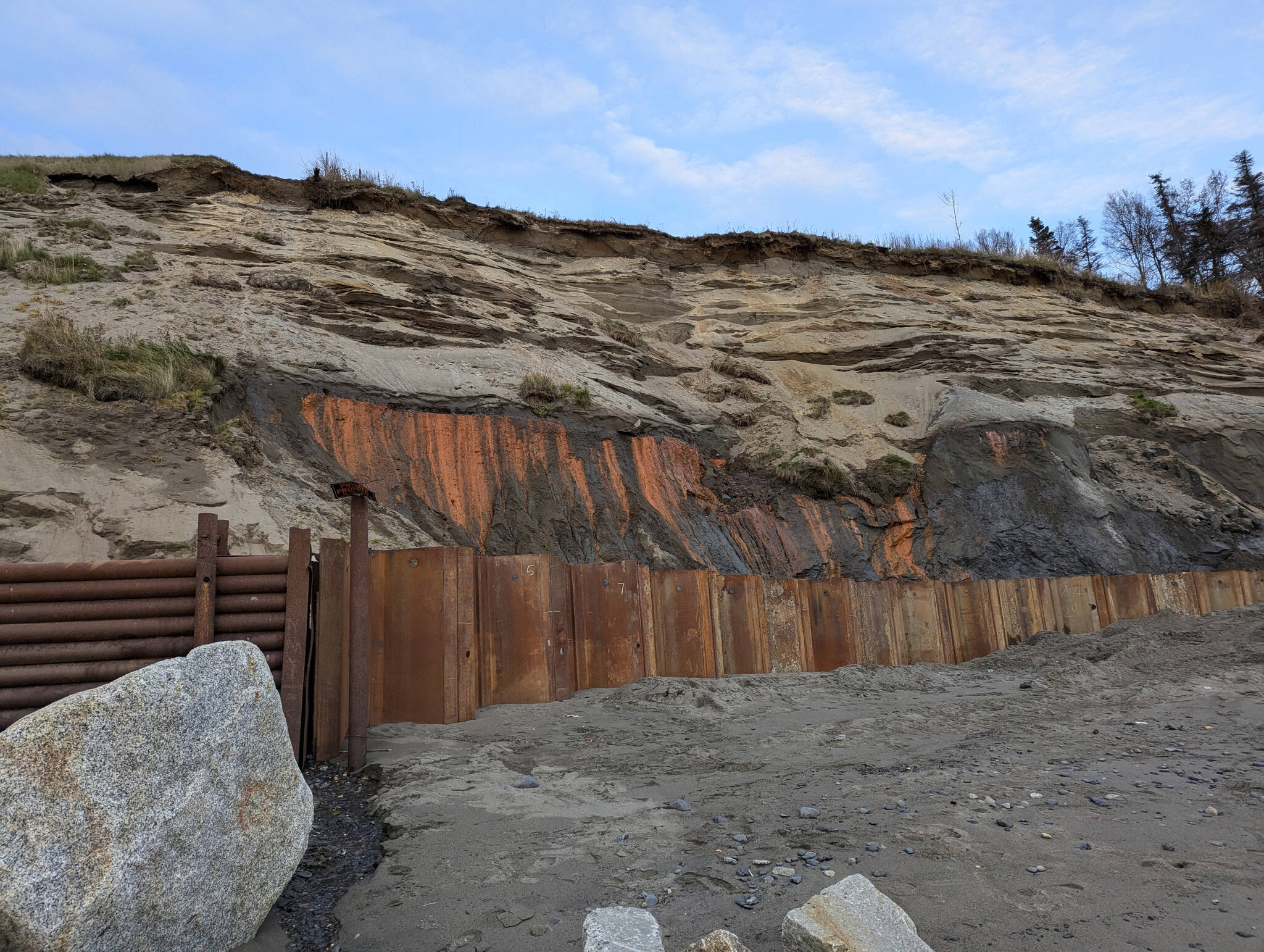 Metal reinforcements line the front of the Kenai Bluff at North Kenai Beach, Tuesday, Oct. 8, 2024, in Kenai, Alaska. (Photo by Erin Thompson/Peninsula Clarion)