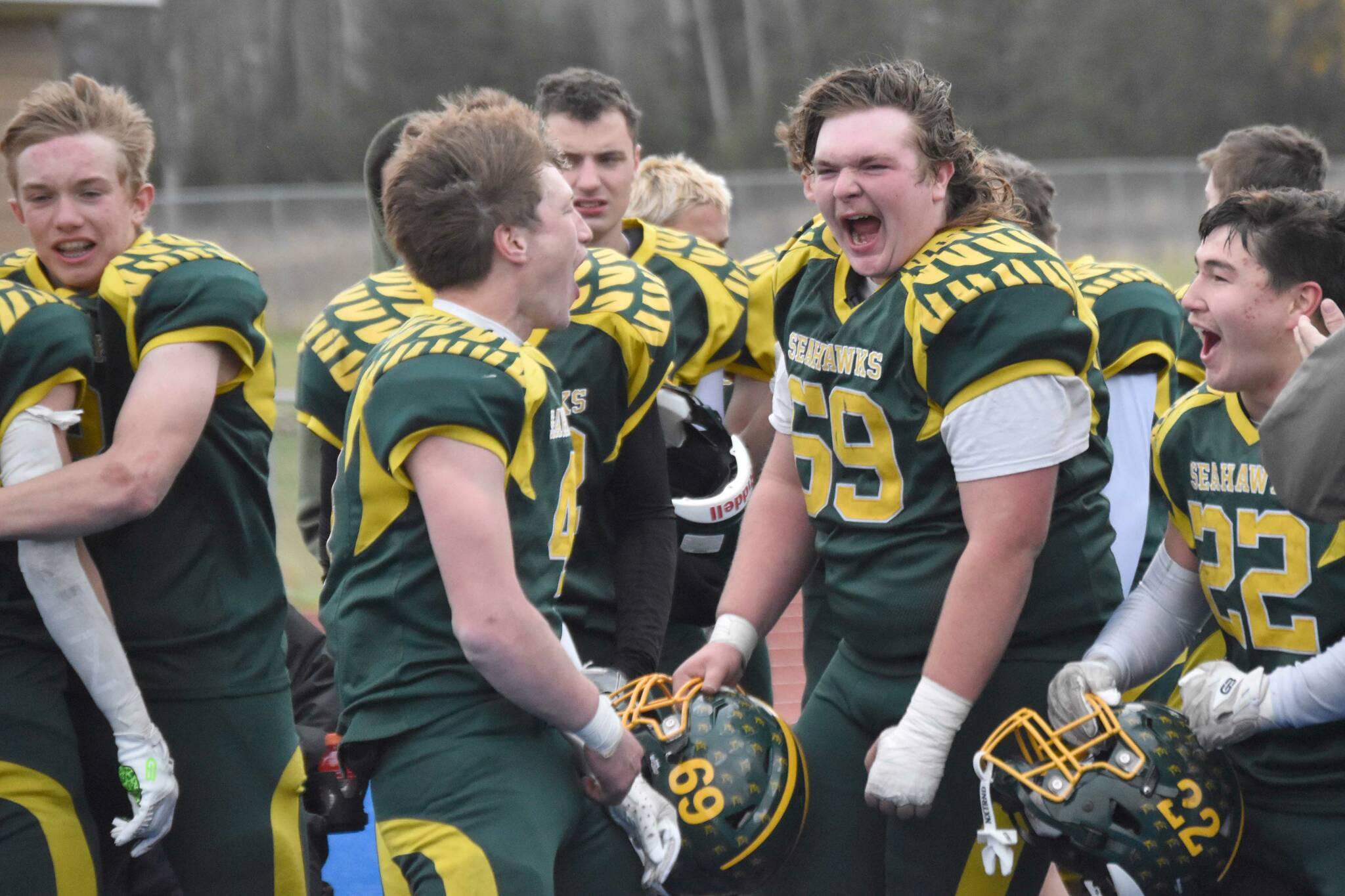 Lane Petersen, Brett Gilmore, Jack Gardner and Noah Price celebrate Seward's victory over Nikiski in the nine-man state championship Friday, Oct. 11, 2024, at Justin Maile Field in Soldotna, Alaska. (Photo by Jeff Helminiak/Peninsula Clarion)