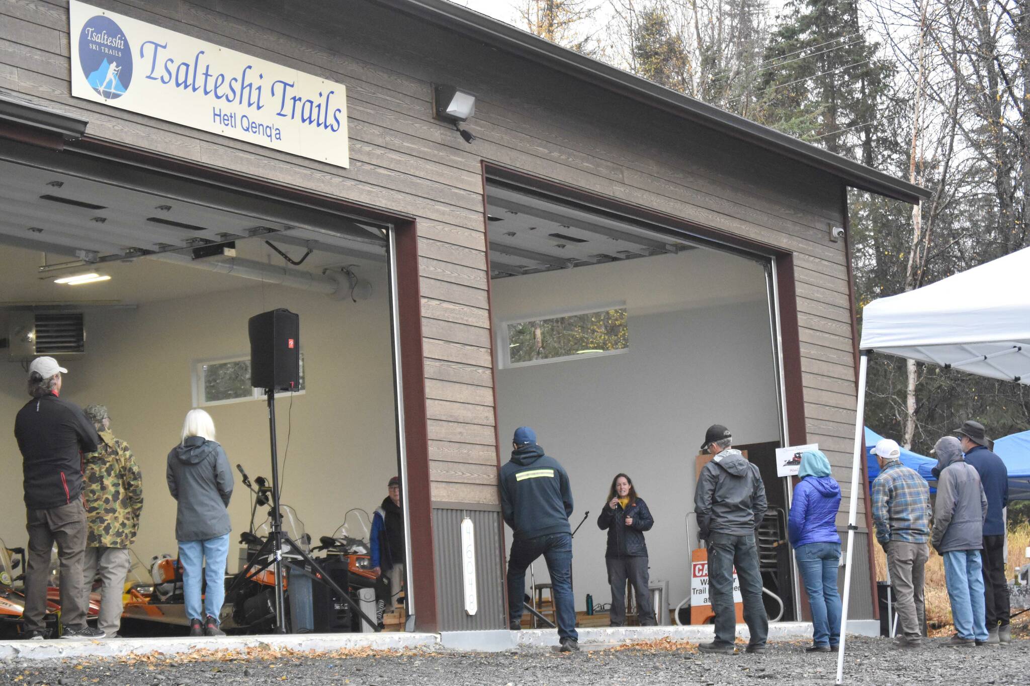 Jenny Neyman, administrative coordinator of the Tsalteshi Trails Association, speaks during a winter kick-off and open house event to celebrate a new maintenance shed Saturday, Oct. 12, 2024, just outside of Soldotna, Alaska. (Photo by Jeff Helminiak/Peninsula Clarion)