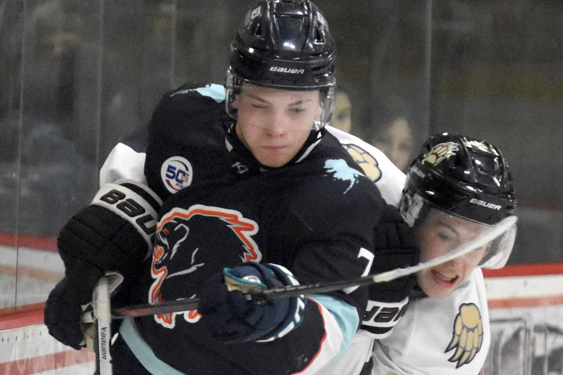 Camden Shasby of the Anchorage Wolverines and Greye Rampton of the Kenai River Brown Bears fight for the puck Saturday, Oct. 12, 2024, at the Soldotna Regional Sports Complex in Soldotna, Alaska. (Photo by Jeff Helminiak/Peninsula Clarion)